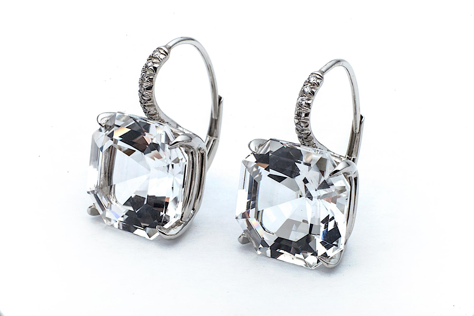 Cool as ice, these large size white topaz Asscher cut gems, weighting a total of 18.83 carats, hang seductively from platinum diamond set wires.  Total diamond weight .09 carats.  Lever backs.  3/4