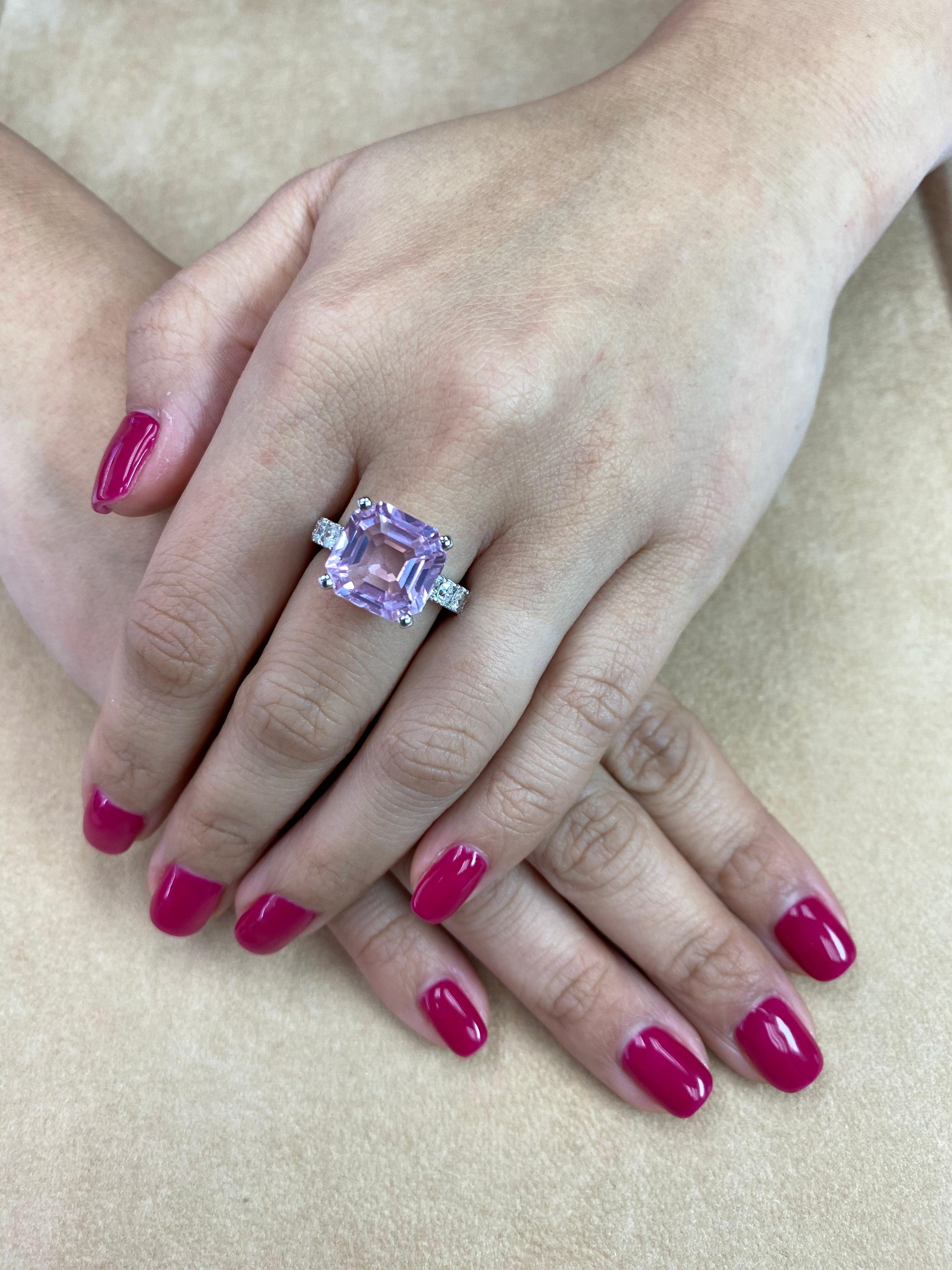 Ask for a video! Here is a beautiful Kunzite and diamond cocktail ring. Oversized at just over 10cts. The ring is set in 18k white gold and diamonds. There are 10 diamonds totaling 1.09 cts on the shanks of the ring. Each side diamond comes out to