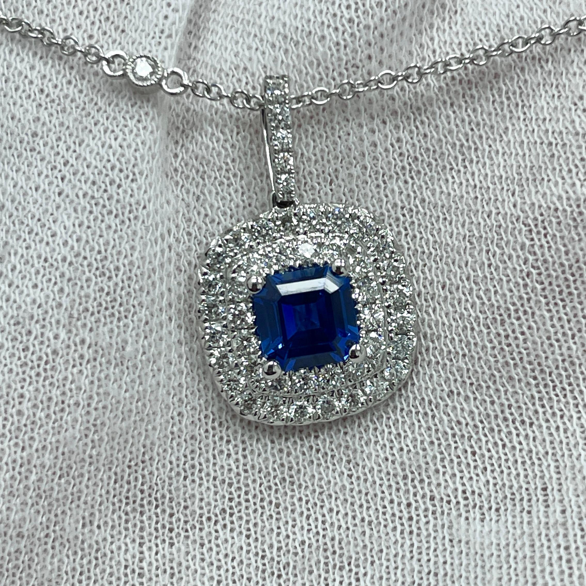 A vivid blue 1.30Ct sapphire in a diamond (0.78Ct) 18K white gold pendant