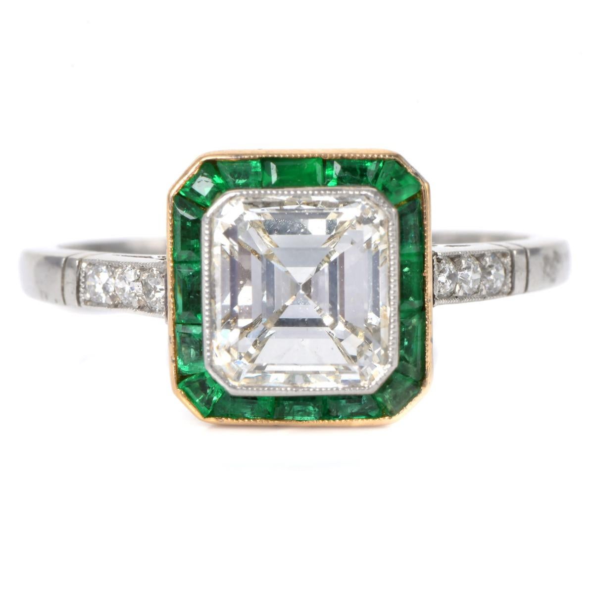 Elegant vintage-style engagement ring, masterfully crafted in platinum.

This piece showcases a 1.54-carat Asscher-cut diamond, VS1 clarity, and G-H color, beautifully framed by 0.48 carats of calibrated natural emeralds and complemented by 0.10