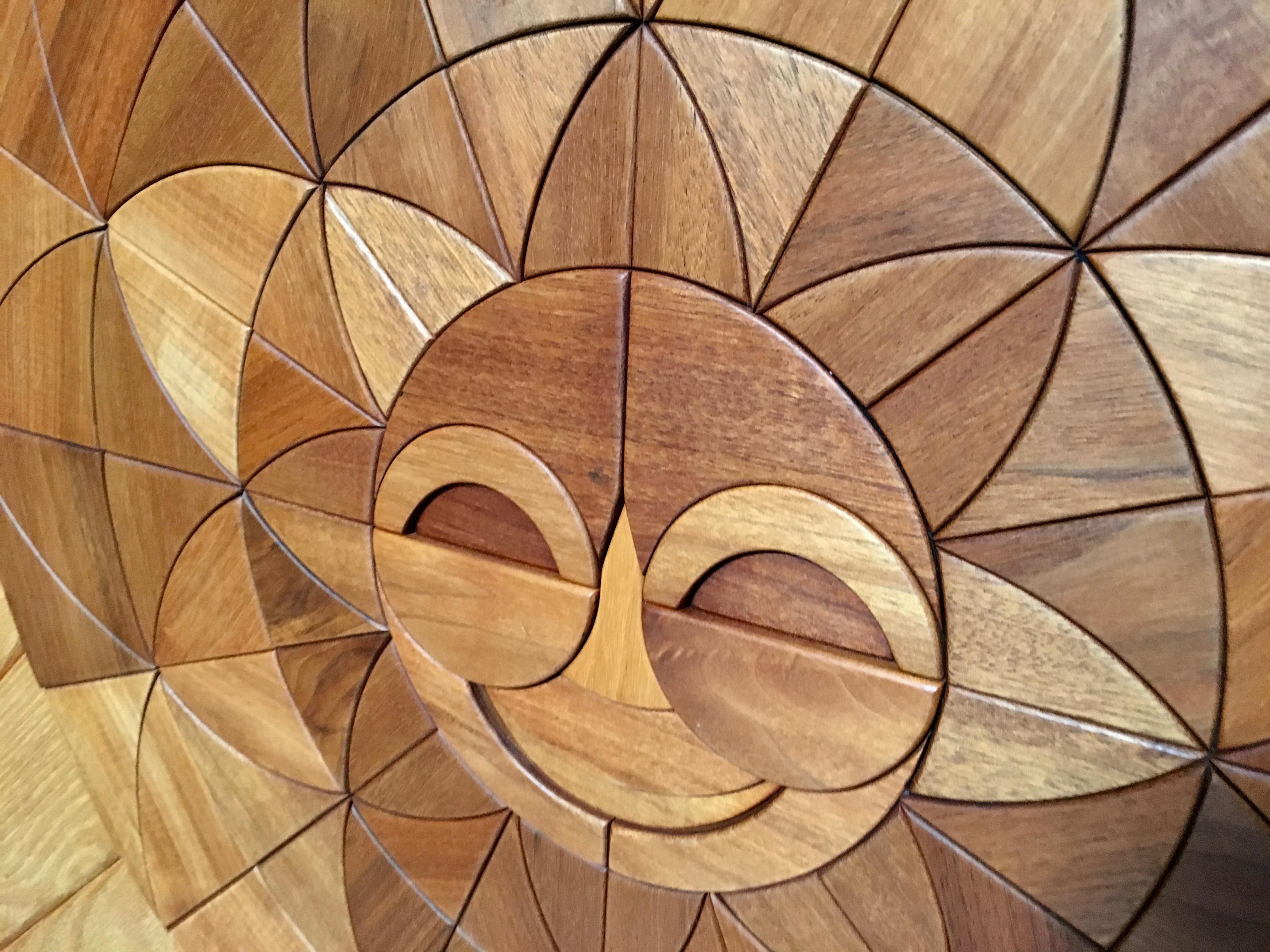 Modern sun burst wall sculpture with relief abstract shapes in multi variety woods. Signed and marked by the artist Dave Criner.