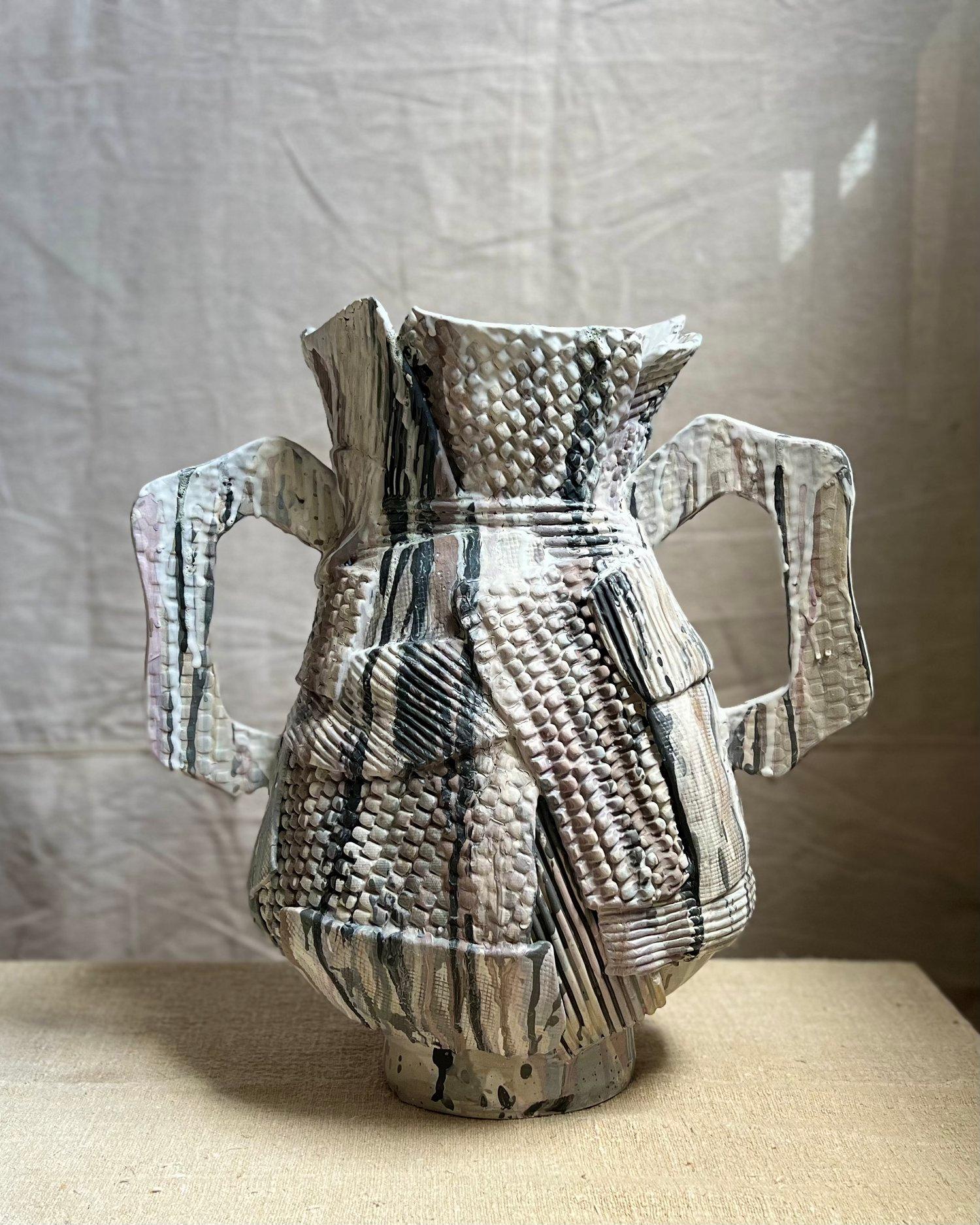 Crafted with the utmost care and artistry, the Amphora Drip Assemblagé Vessel is a captivating work of functional decor that embodies the essence of wabi-sabi. This large, one-of-a-kind amphora-inspired vessel is a masterpiece of porcelain,