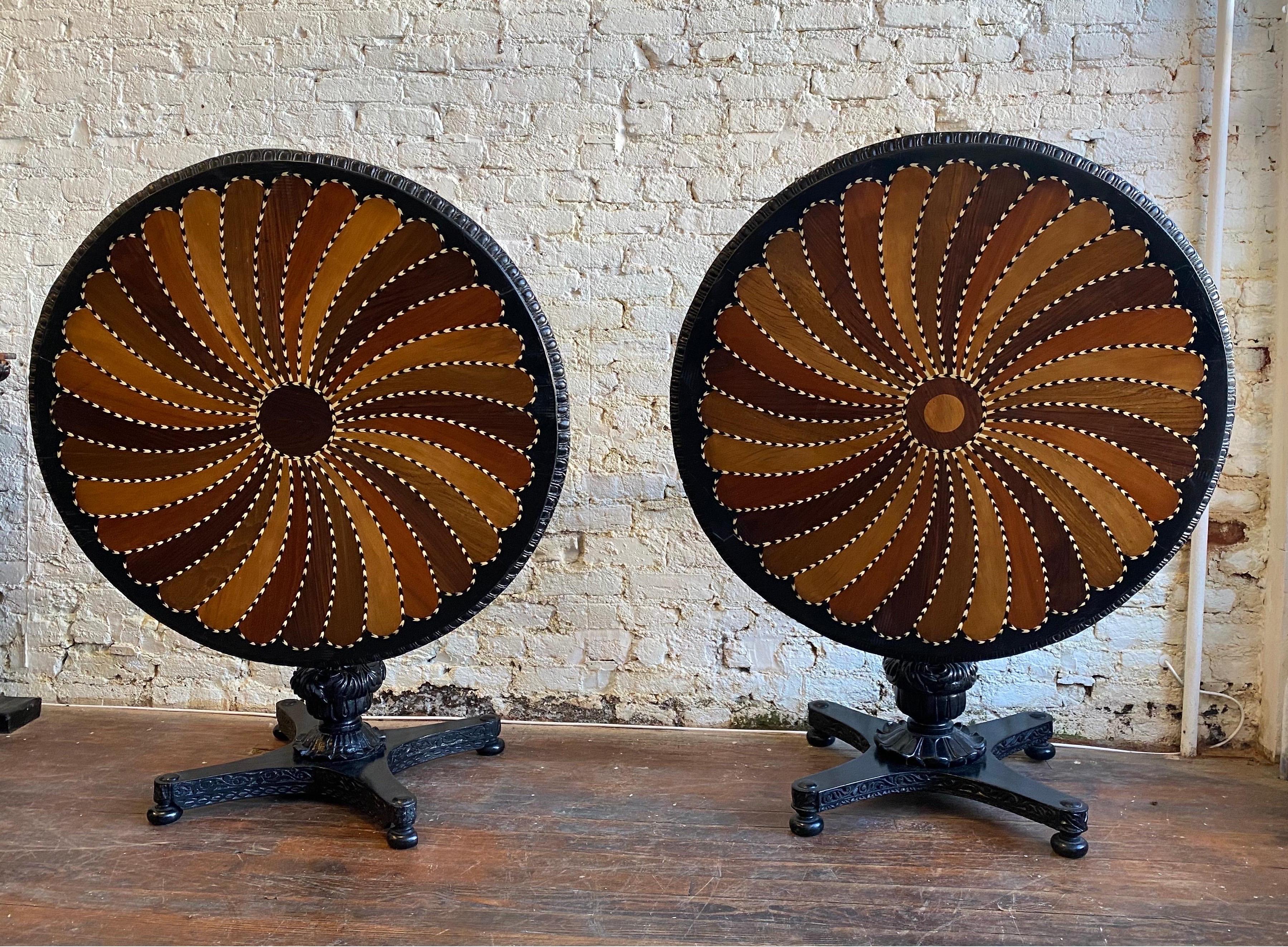 Fantastic near pair of 19th century British colonial Ceylonese specimen top tables. Made in British Ceylon during the 19th century, these tables are gorgeous. Ebonized bases with inlaid tops. 

These two Anglo Indian tables are very similar- the