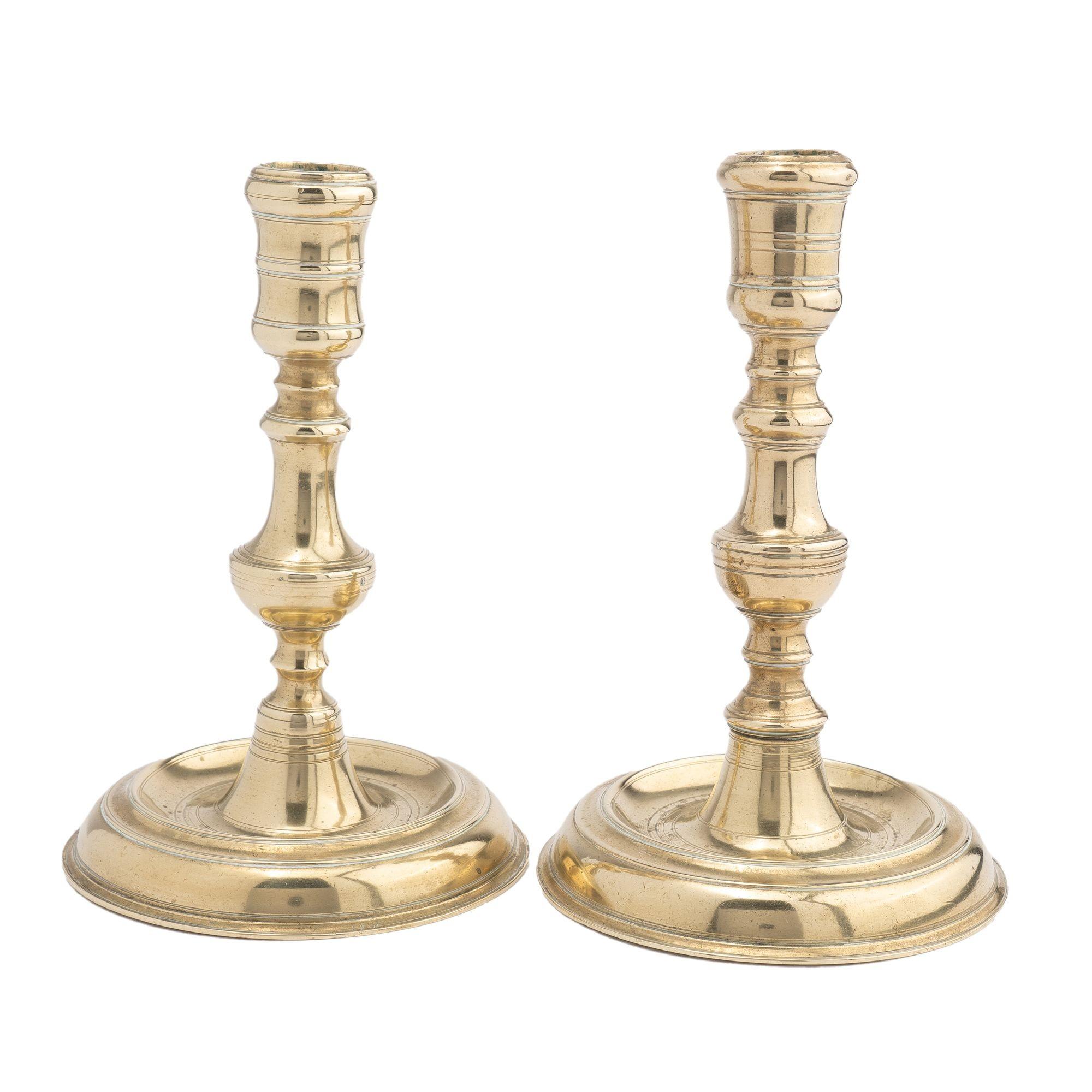 Assembled pair of cast brass chamber candlesticks with the same impressed monogram reading 