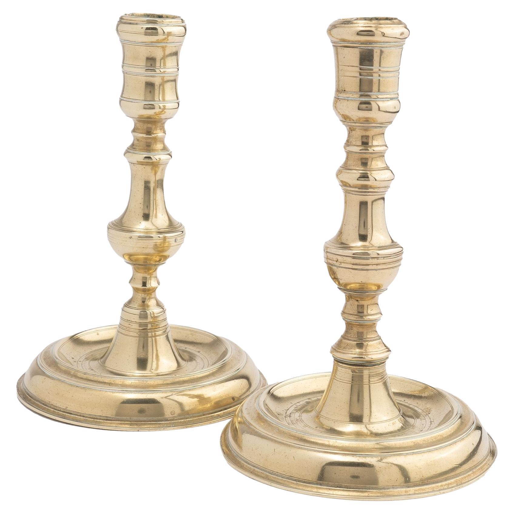 Assembled pair of French cast brass chamber candlesticks, 1710-20 For Sale