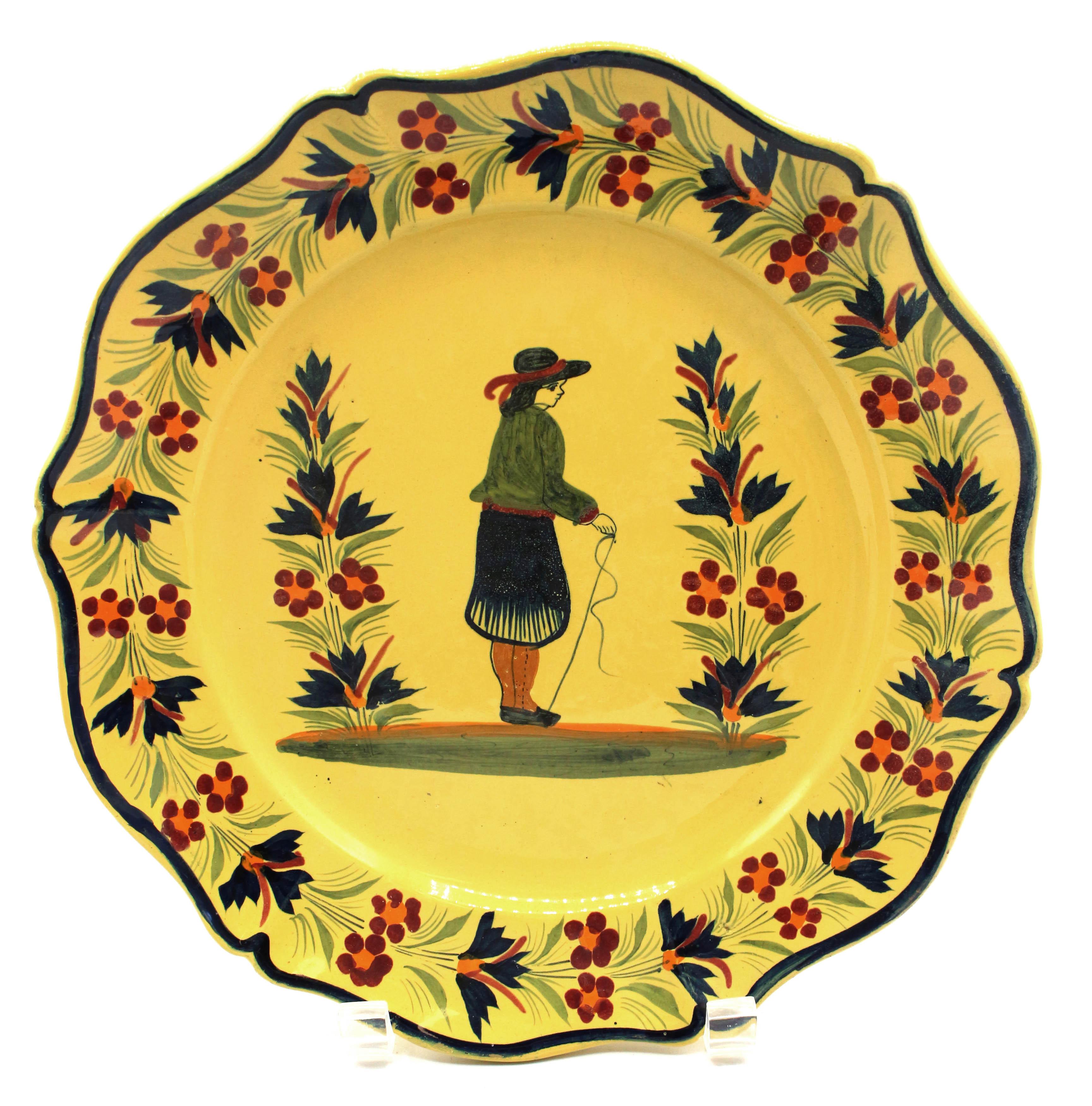 An assembled pair of large yellow ground Quimper plates, mid-20th century. Henriot Quimper, with 1922-1968 marks. The man & woman in traditional Breton garb. Mildly rubbed surfaces.
10