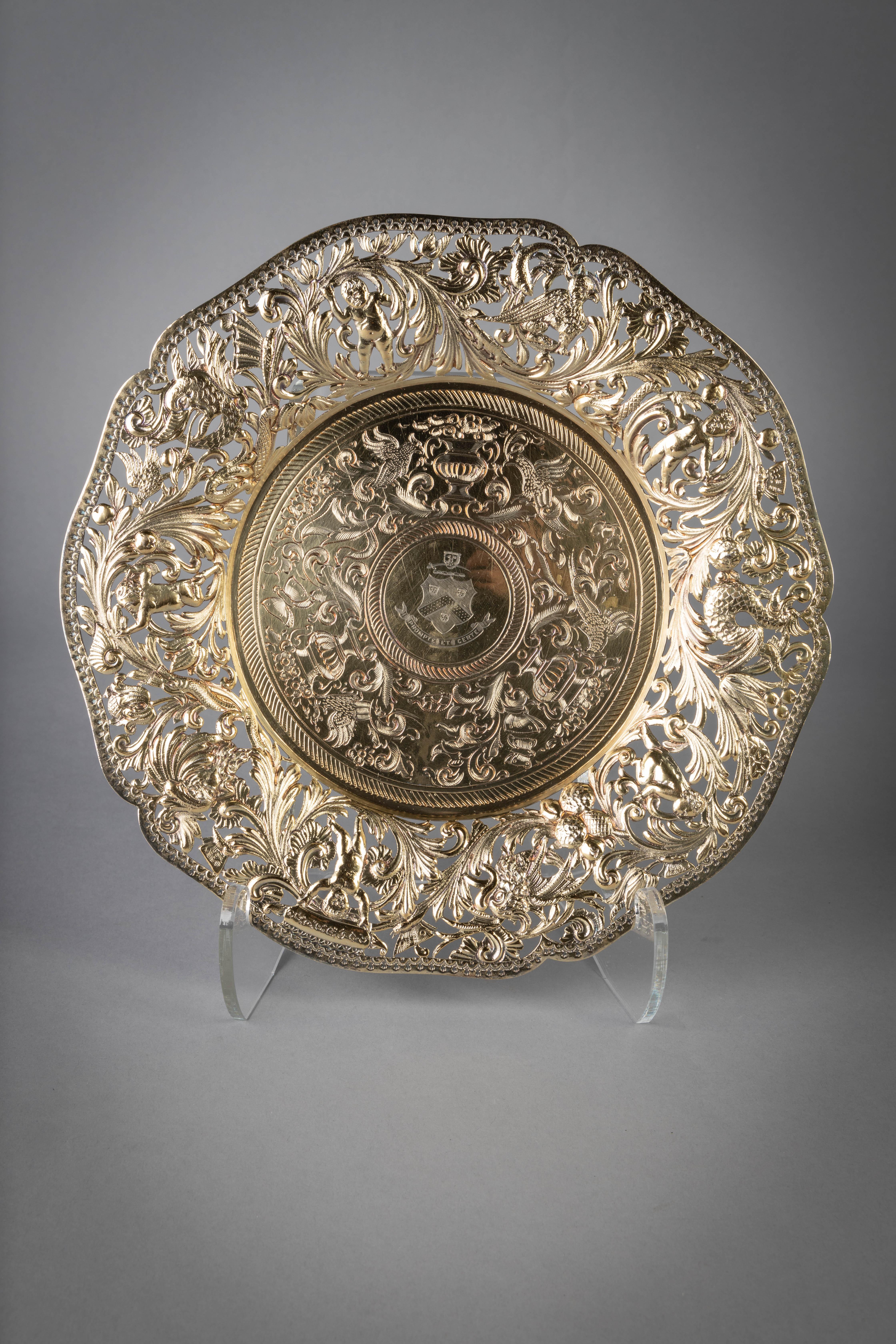 Comprising 11 German plates circa 1880, 5 English silver Victorian plates, 3 Georgian silver plates. Each centered with an identical crest with motto 'Prompte Et Certe' surrounded by engraved scrollwork and vases with flowers flanked by birds and