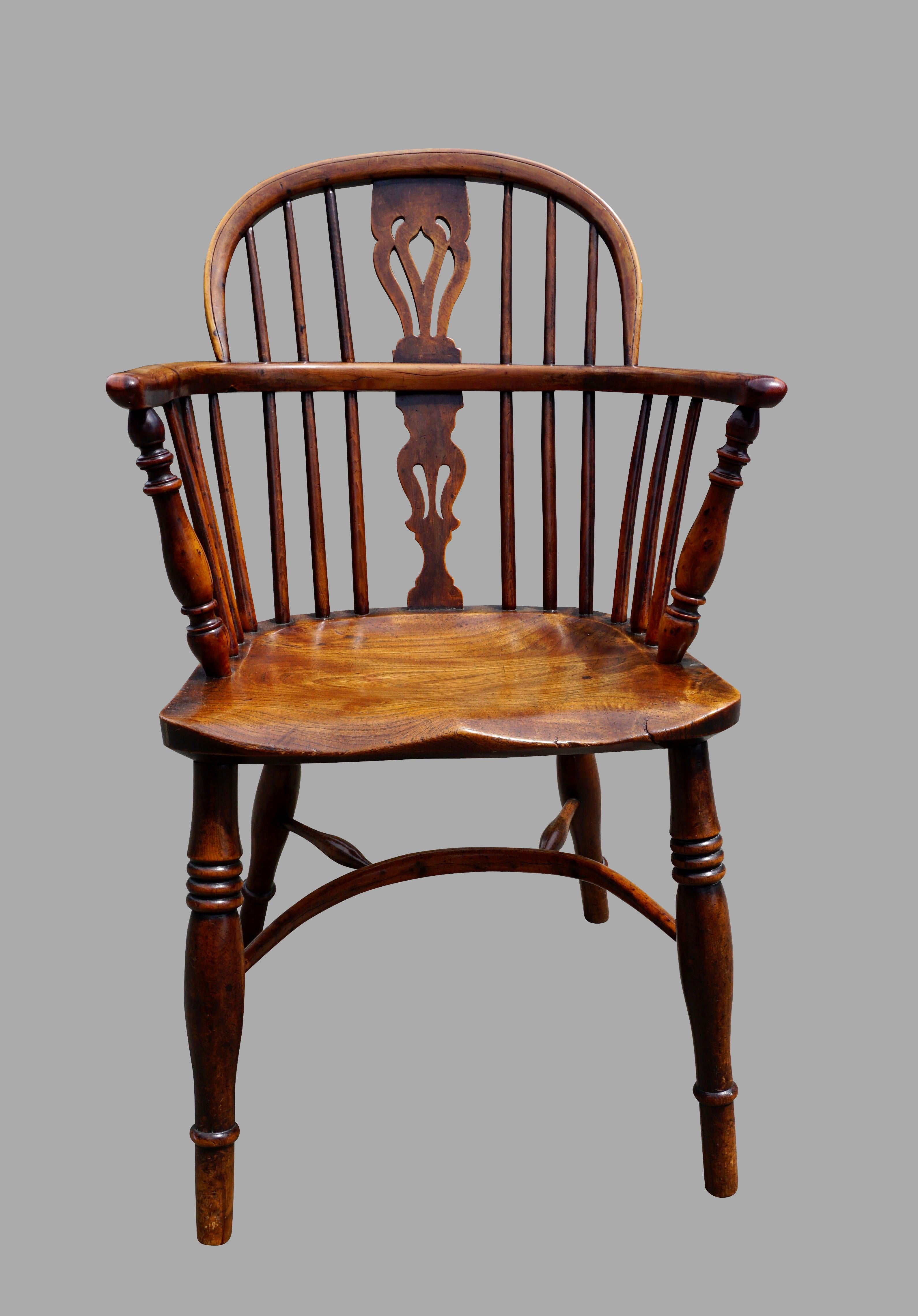 An assembled set of 6 yew wood and hickory low back Windsor arms chairs of typical form, with minor variations in size, each with a pierced splat back, saddle seat and crinoline stretcher. A hard to find set in yew wood, these chairs sit well and