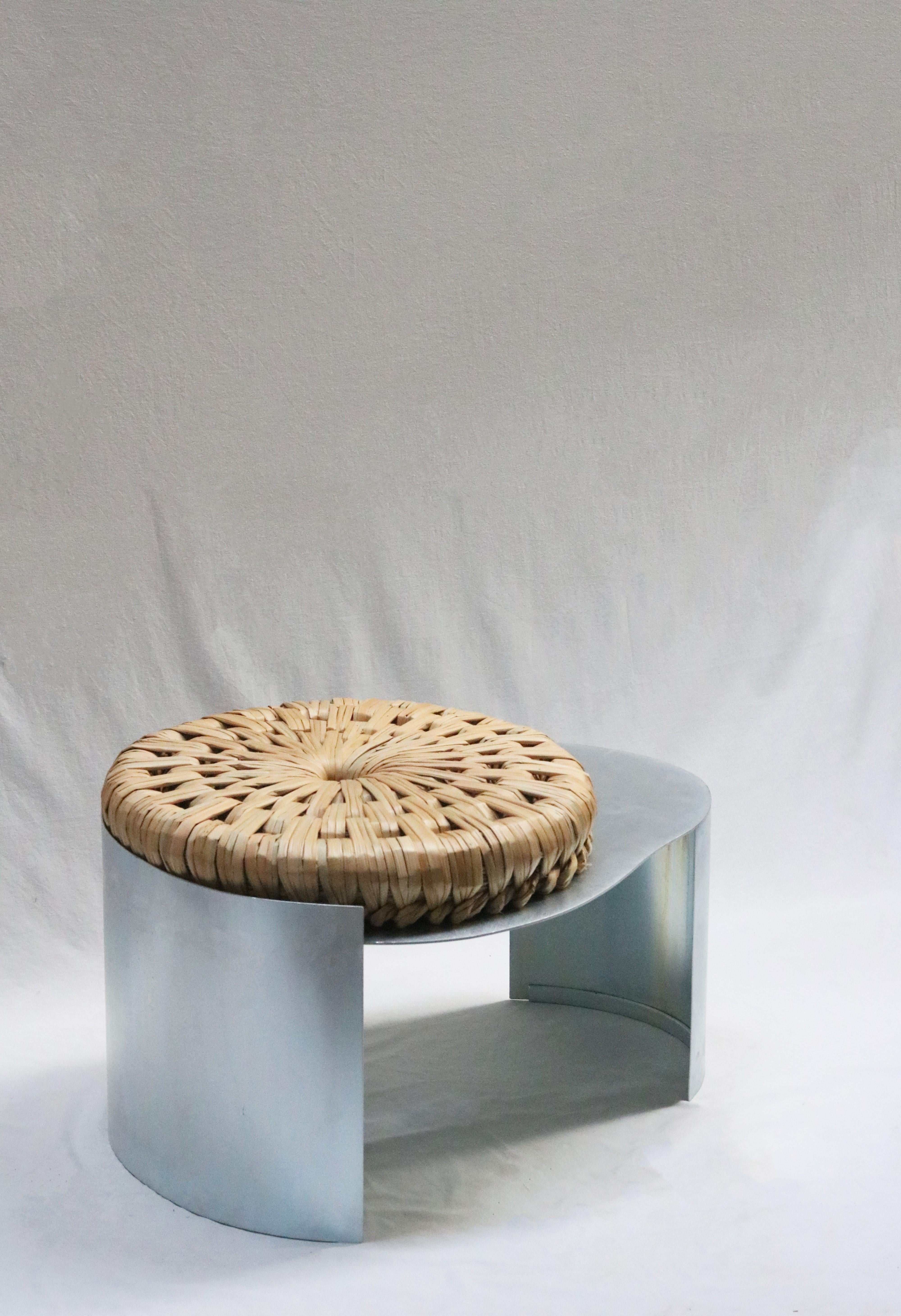 Assento Stool by Macheia
Handmade In Portugal.
Dimensions: D 55 x W 75 x H 40 cm.
Materials: Natural dried bulrush and galvanized iron.

Inspired by Tanho, the most iconic piece of the Bunho technique, Assento is a hybrid between a sitting stool and