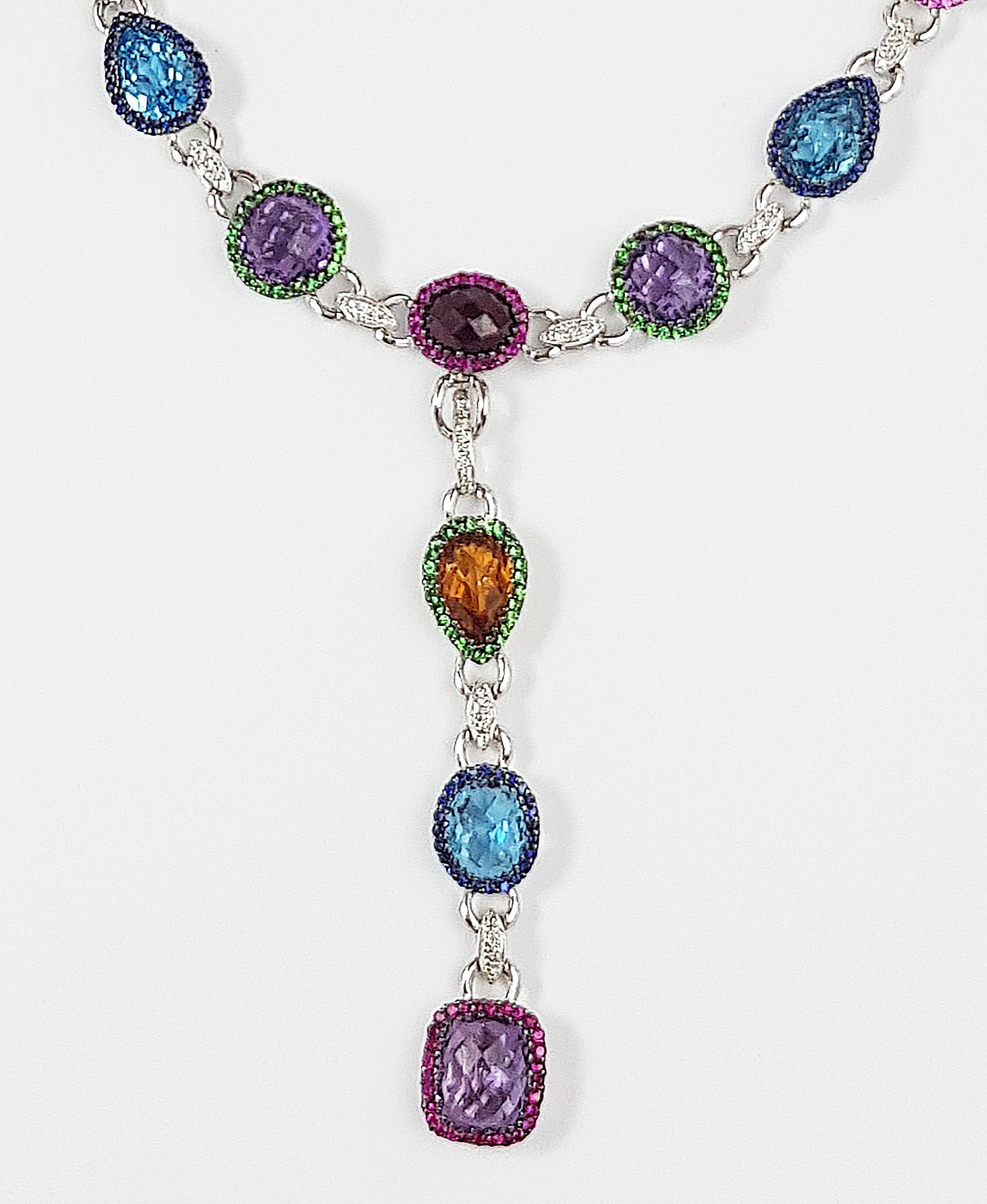 Assorted Colour Semi- Precious Gem Stones 43.75 carats with Ruby, Blue Sapphire, Fancy Sapphire and Tsavorite 4.69 carats and Diamond 0.46 carat Necklace set in 18 Karat White Gold Settings

Depth:  6.2 cm 
Length: 40 cm
Total Weight: 46 grams

