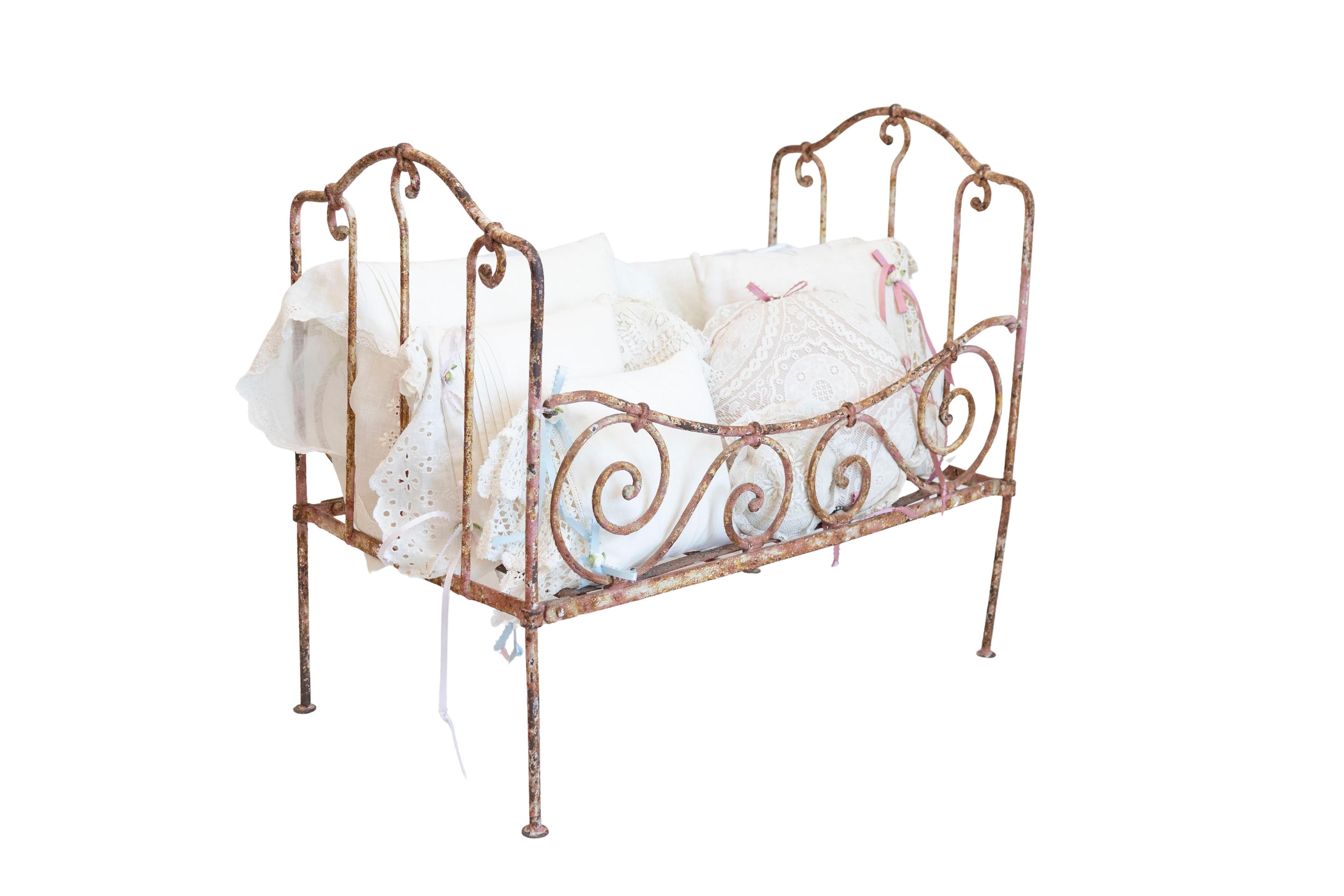 Assortment of Vintage Lace Pillows in 19th Century Metal Crib with Great Patina
