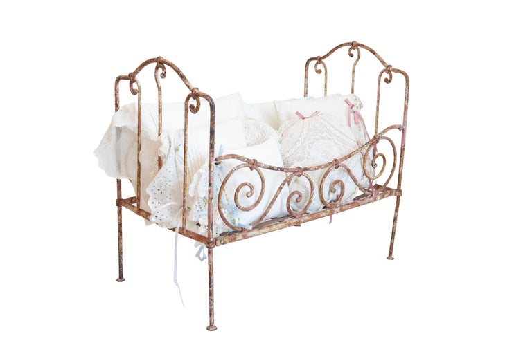 Assortment of Vintage Lace Pillows in 19th Century Metal Crib with