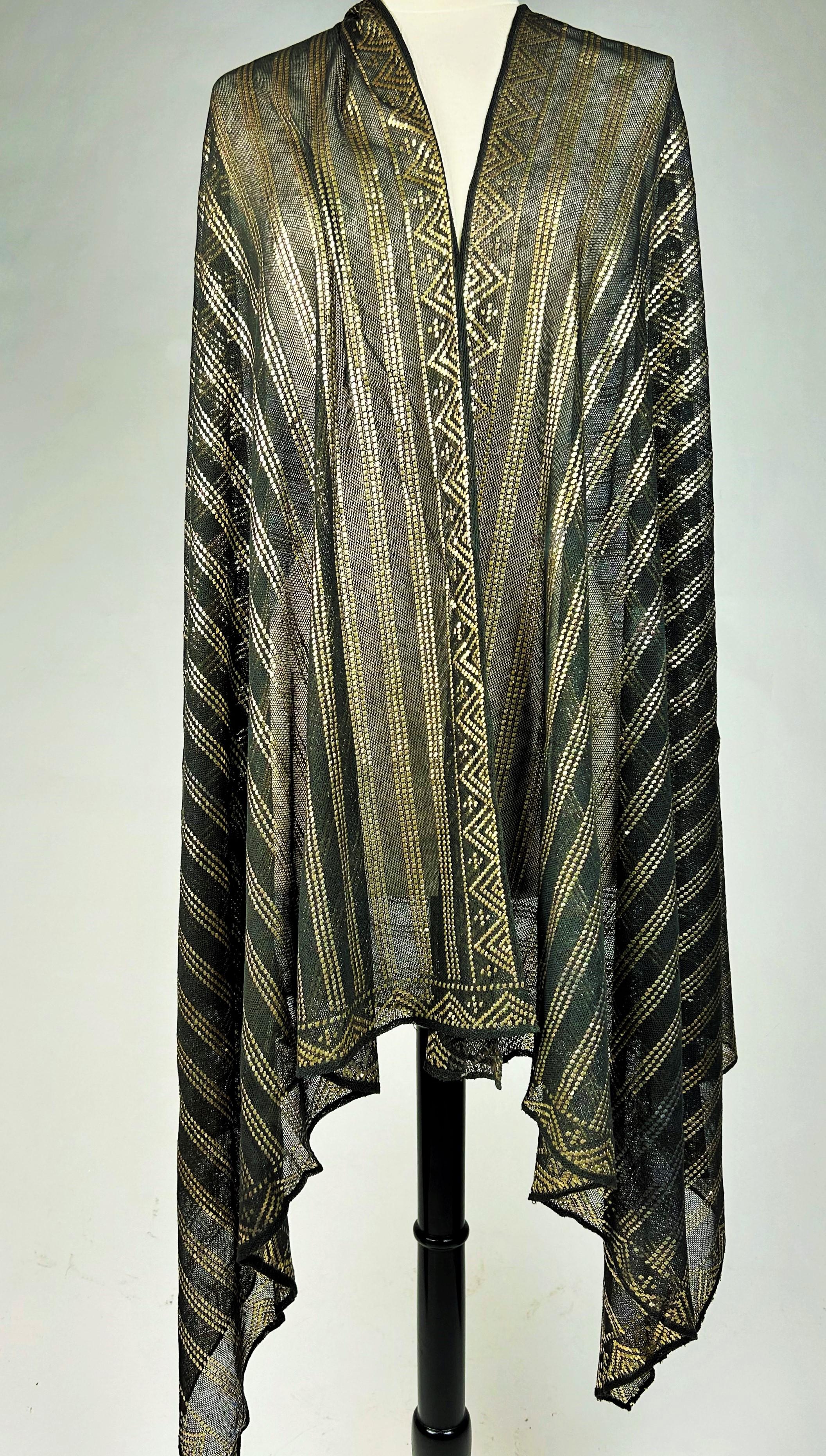 Circa 1930-1940

Egypt

An elegant black and gold shawl or stole from the Art Deco period, known as the Assuit Shawl, made in Egypt for Western fashion during the 1920s-1940s. The Egyptomania craze began in Europe after the discovery of