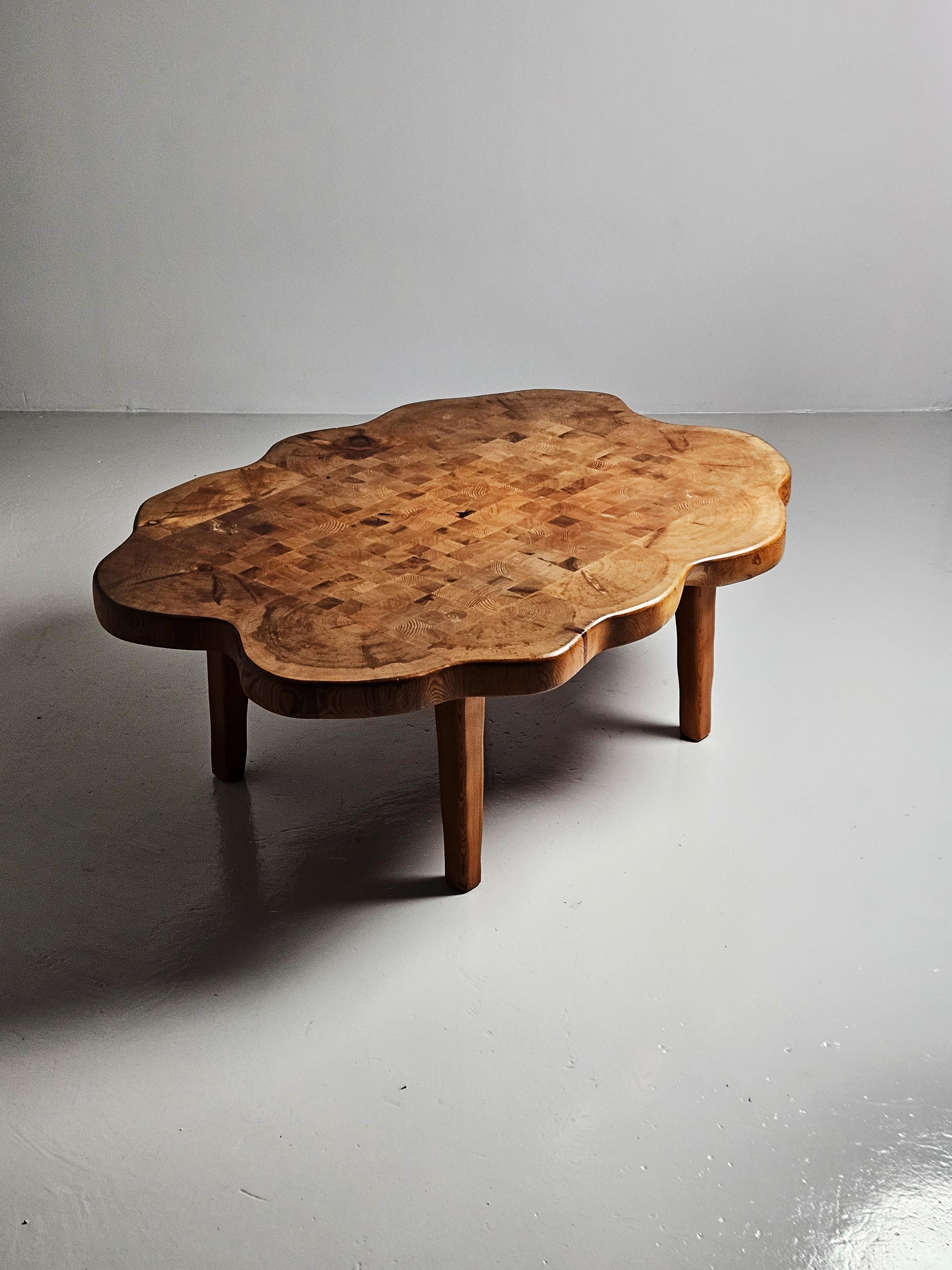 Beautiful and unique assymetrical coffee table in pine. Designer is yet unknown but the craftsmanship is truly spectacular. 

Made in the 1960s or 1970s in Sweden. 

Very big and heavy. 