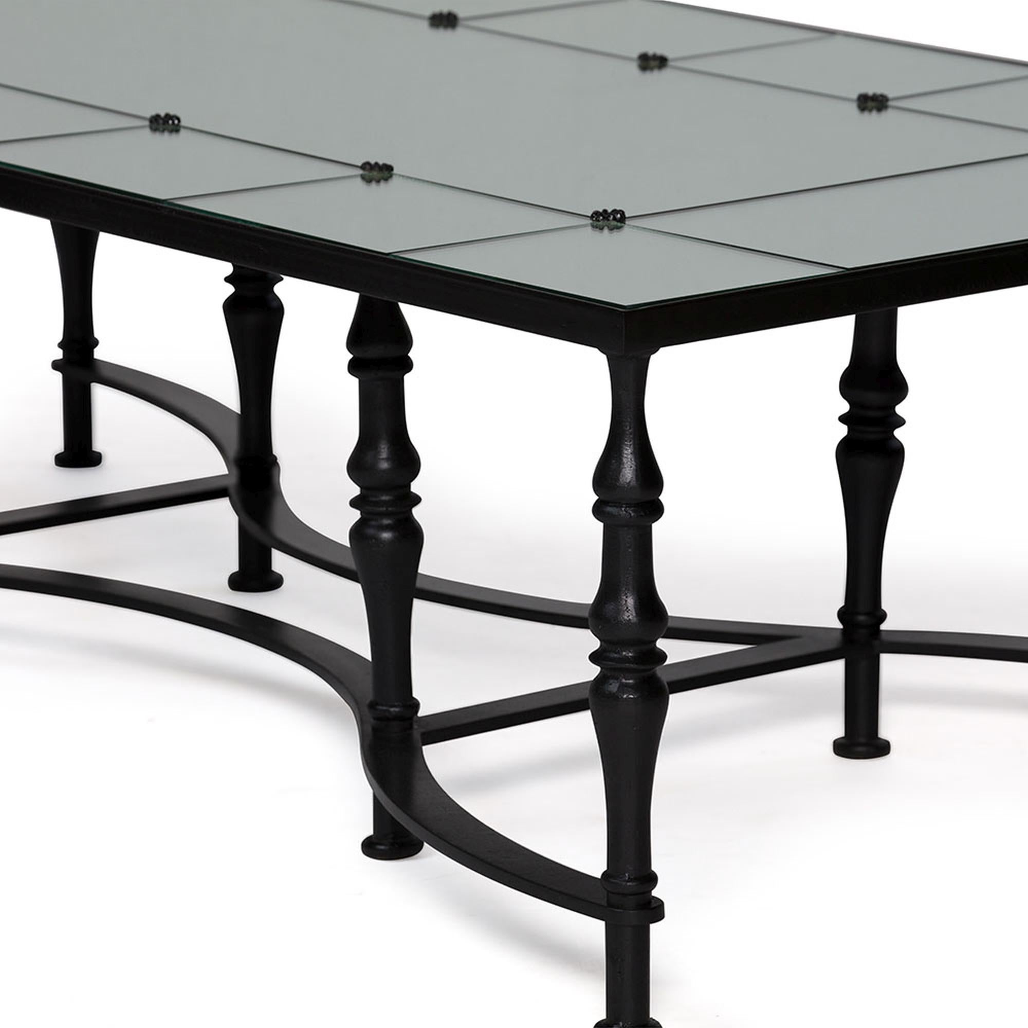 Providing an edge of sophistication and detail, the Astaire coffee table features a mirrored top and is accented with ebony metal rosettes and a flawless shape. The turned metal legs and mirrored effect offer a dramatic look while maintaining a