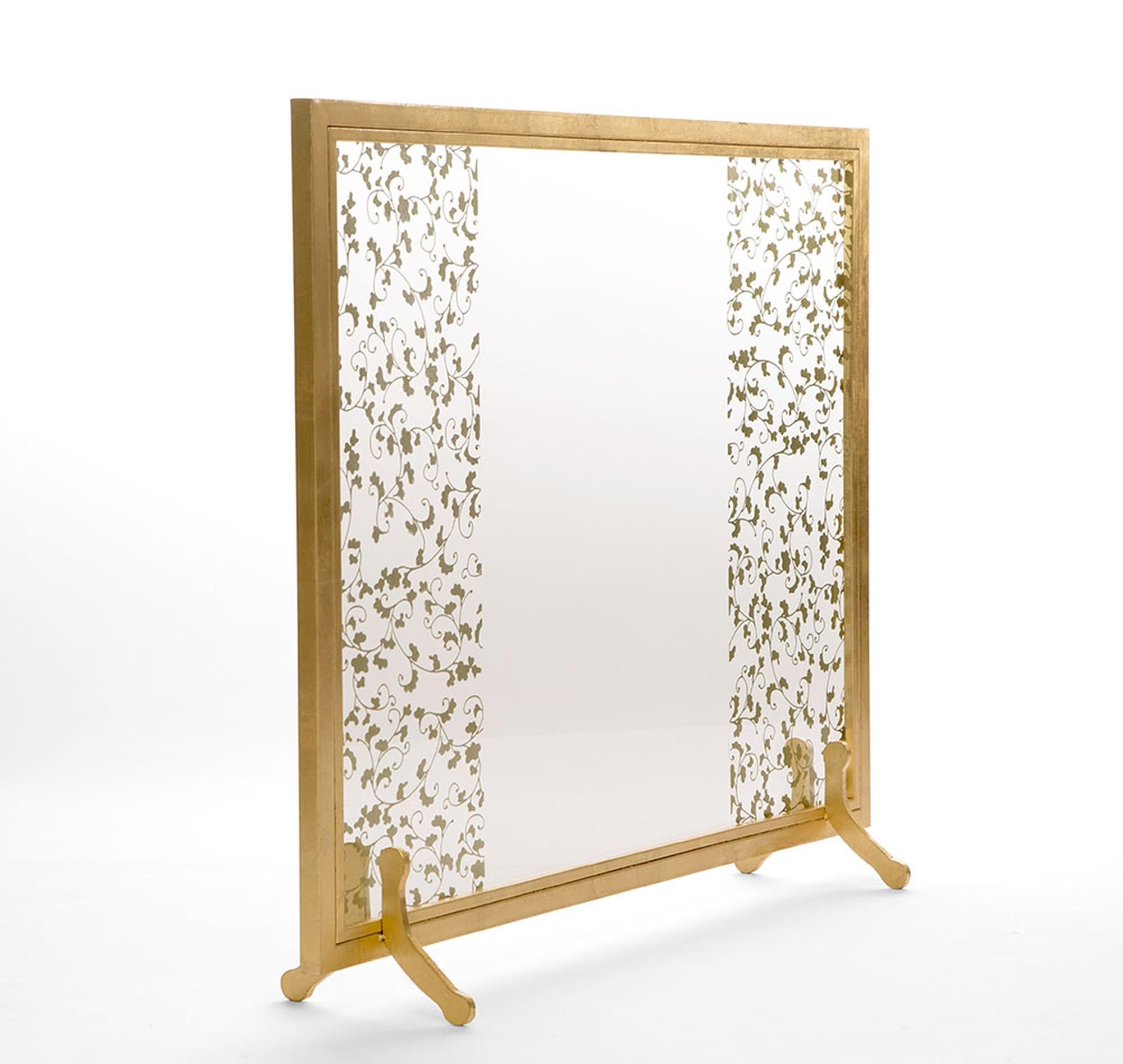 The Astaire fireplace screen complements the design and aesthetic of the Astaire collection, with its delicate and ornate detailing. A hand-embellished floral design is placed on a tempered glass panel, and a hand gilded metal frame supports the