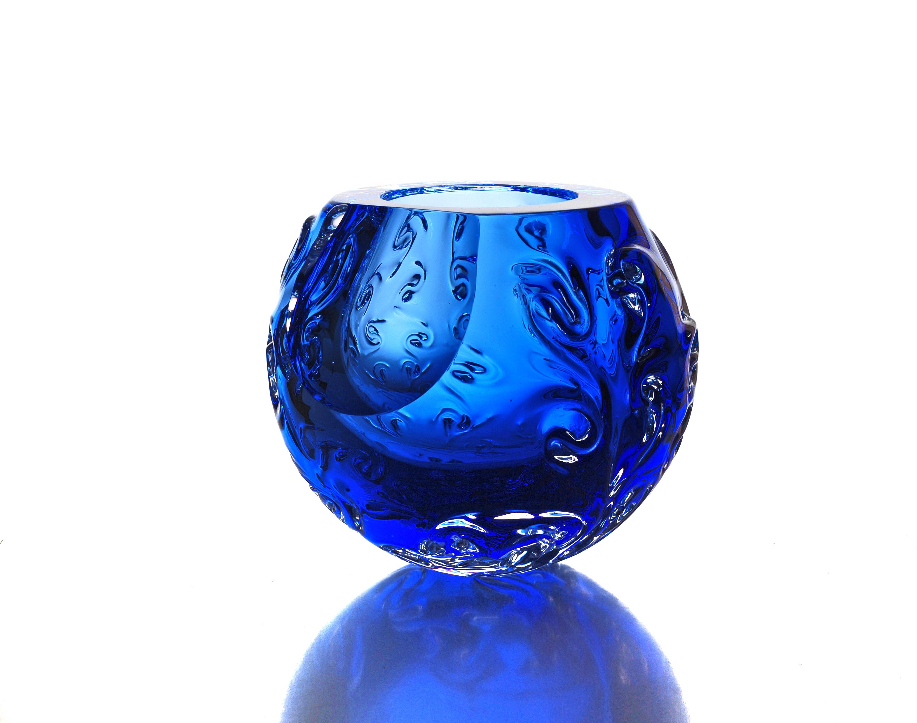 Structural bowl with iconic organic design. Vessel made of solid blue hand sculptured glass. It represents planet - asteroid, fragment of cosmic matter. Bowl is created by spontaneous shaping of hot glass mass without the use of any mold. Big faset