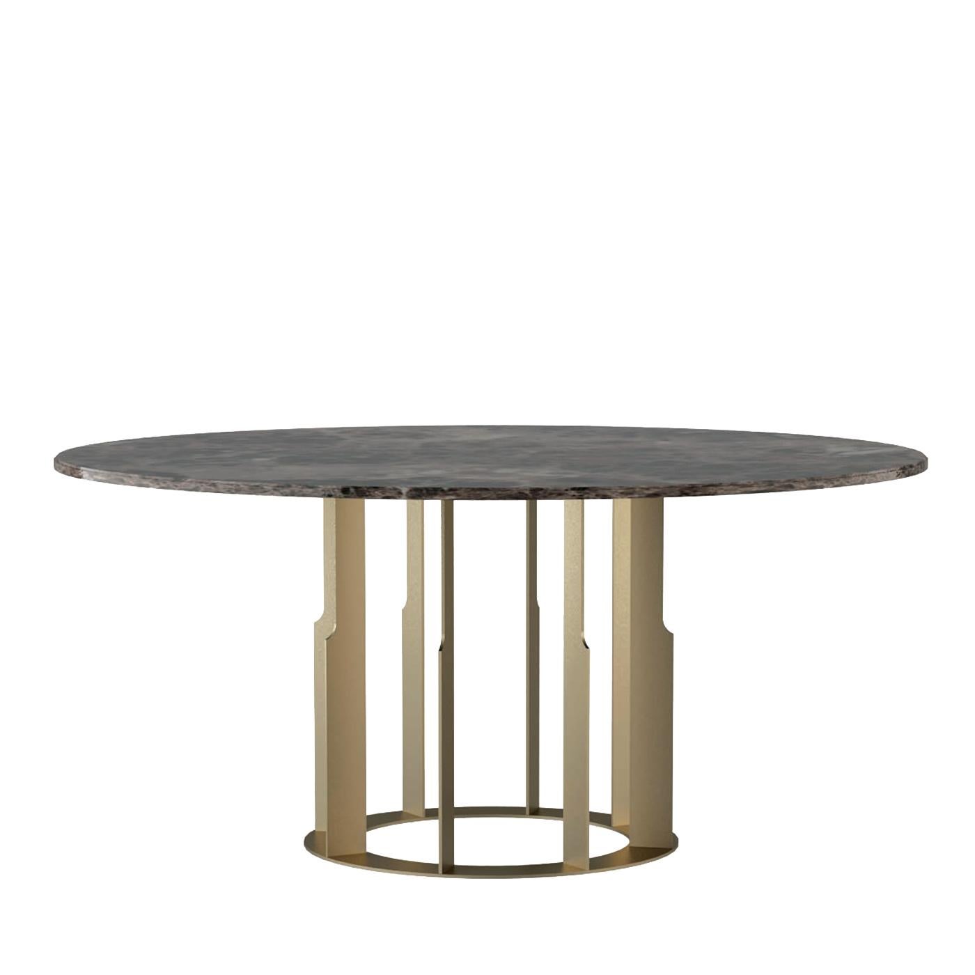 Balanced on a stainless steel pedestal in polished brass finish with eight irregularly-edged vertical elements placed on a circular base, this striking dining table will be a sculptural focal point in any dining room or living area. The top is an