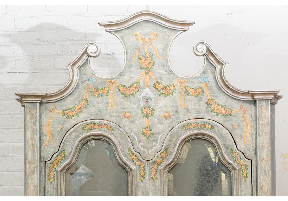 A tall custom Venetian baroque shaped frame, the double doors with inset beveled antiqued mirrors open to two shelves. The slant front opens to drawers and a cubby hole. The lower cabinet with three long drawers.
Overall distressed look green/gray