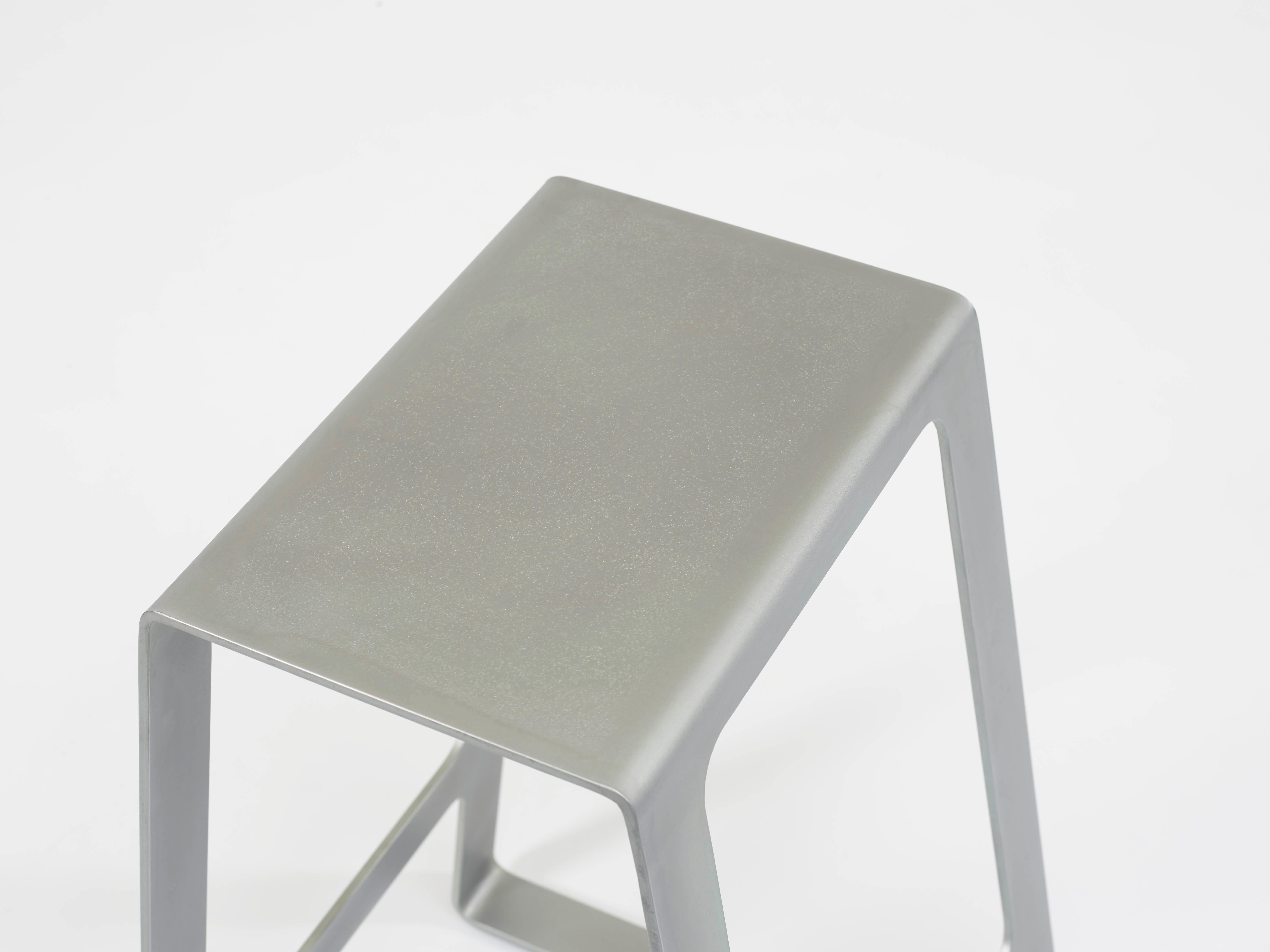 A_Stool bar height stool in zinc-plated steel. A minimal, backless design in steel with a durable coating of zinc. Also available in brushed, sanded, or polished finish. Signed, dated and numbered to the underside with a laser-etched aluminium