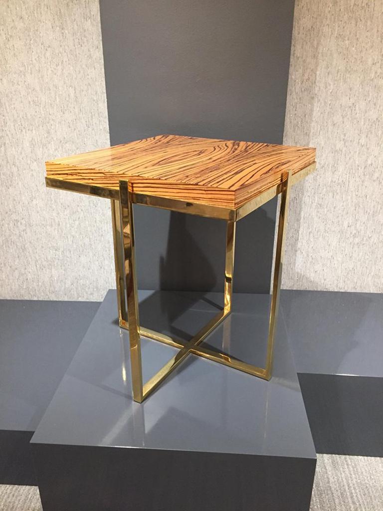 The Astor side table, designed by Irwin Feld for CF Modern, has a metal frame which holds a custom slab of wood. Shown here in Zebrawood and polished brass. 

CF Modern merchandise is available in custom sizes, wood and hardware finishes, COM and