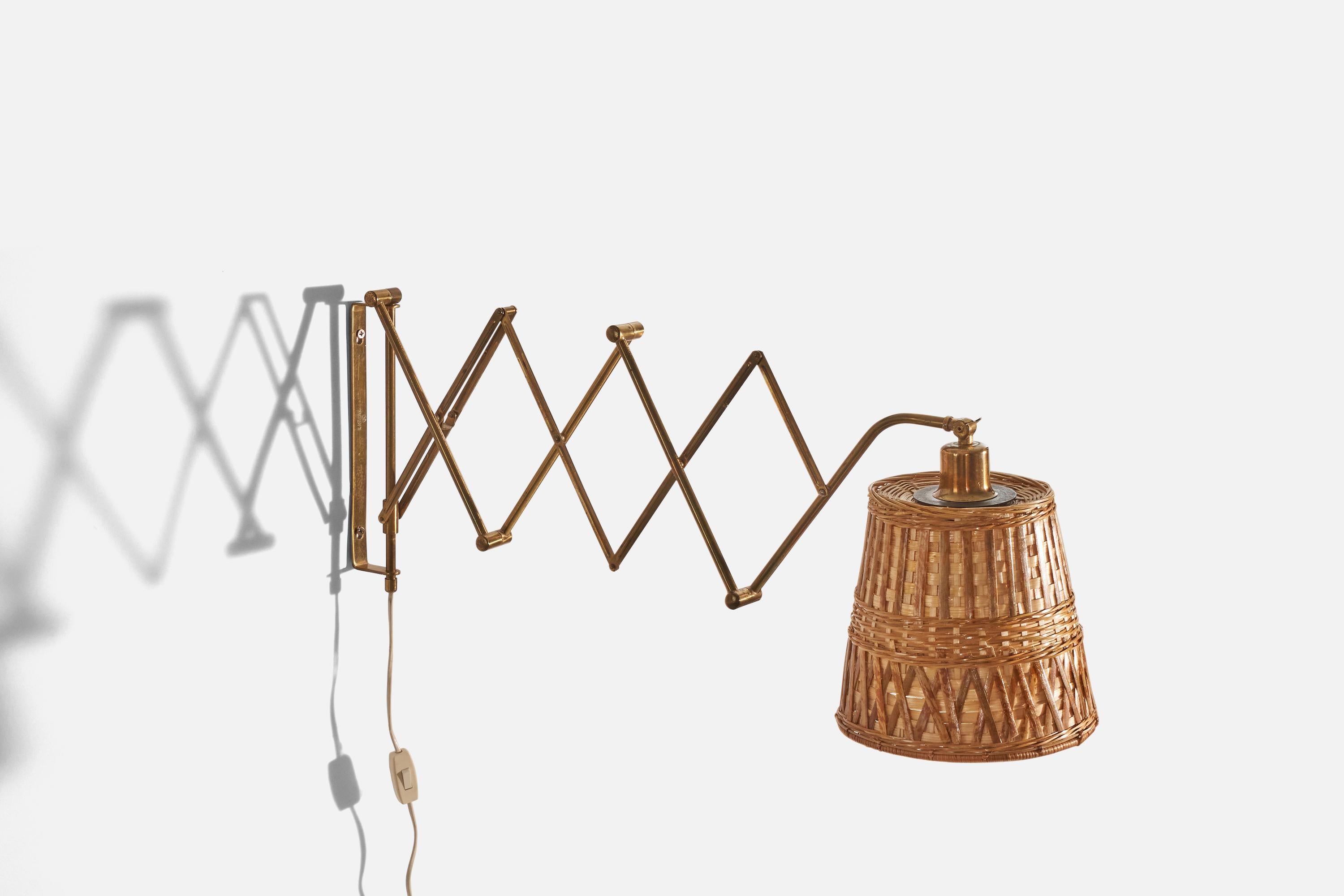 An adjustable, brass and rattan wall light, designed and produced by Astra, Norway, c. 1940s. 

Variable dimensions, measured as illustrated in the first image. 

Sold with lampshade. 

Dimensions of back plate (inches) : 10.5 x .75 x 2.06 (H