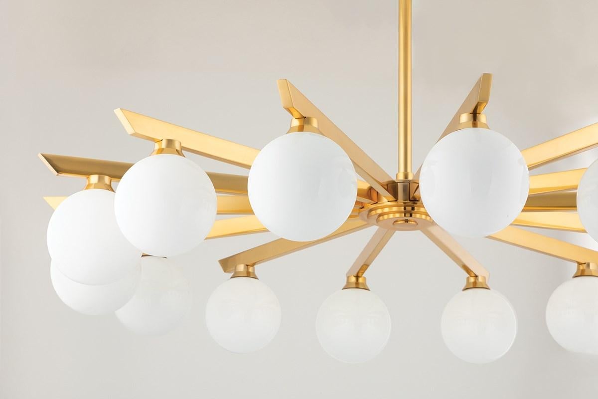 Astra is close to the ceiling and far from ordinary.
Opal shiny glass globes suspend from the arms of vintage brass
The arms extend evenly from a central focal point, casting beautiful light in every direction
With its air of vintage Hollywood