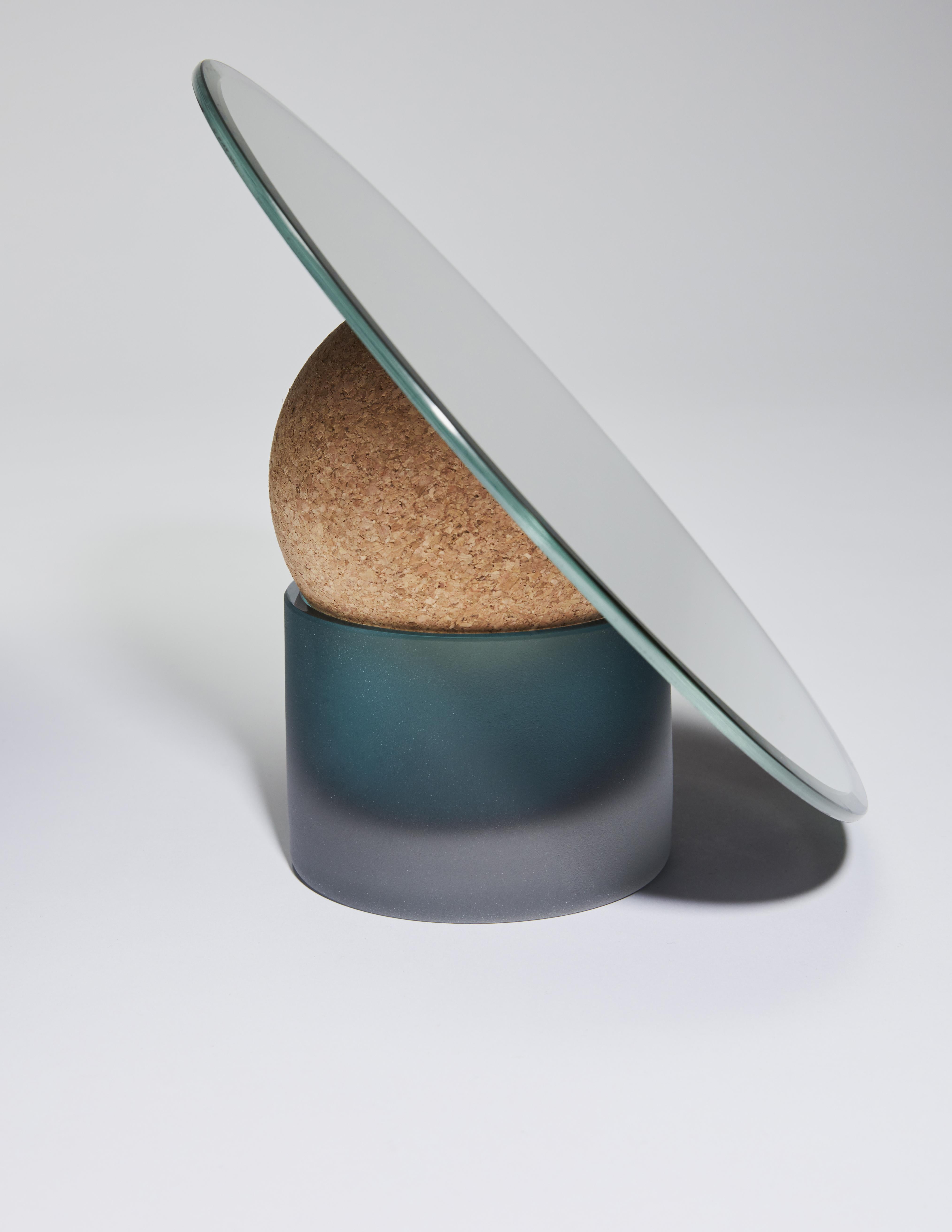 Astra table mirror-24 by Clemence Birot
Dimensions: Mirror Ø 24 x 20 cm
Materials: mirror, glass, cork. 

Clemence Birot started her career in Copenhagen, Denmark, and discovered a design practice closely related to craftsmanship. The latter