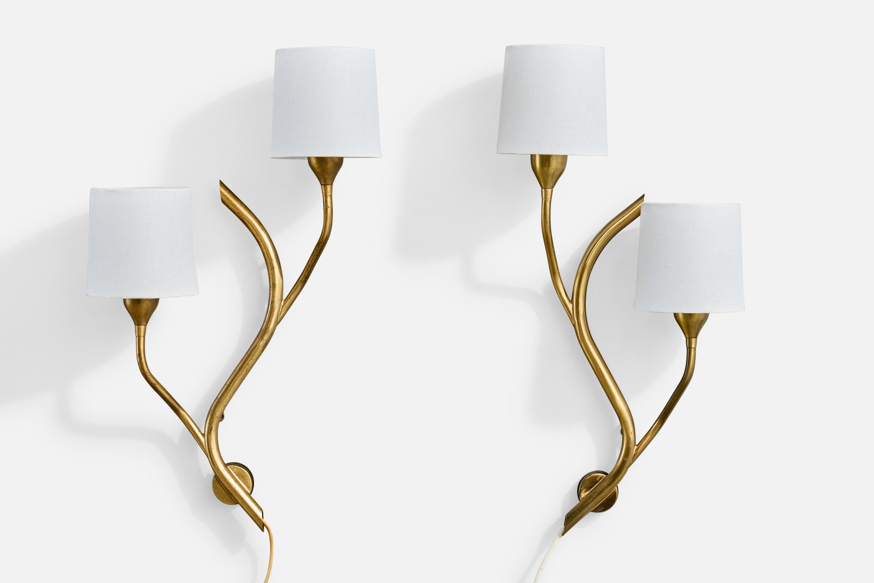 A pair of brass and white fabric wall lights produced by Astra, Norway, c. 1950s.

Overall Dimensions (inches): 20.5