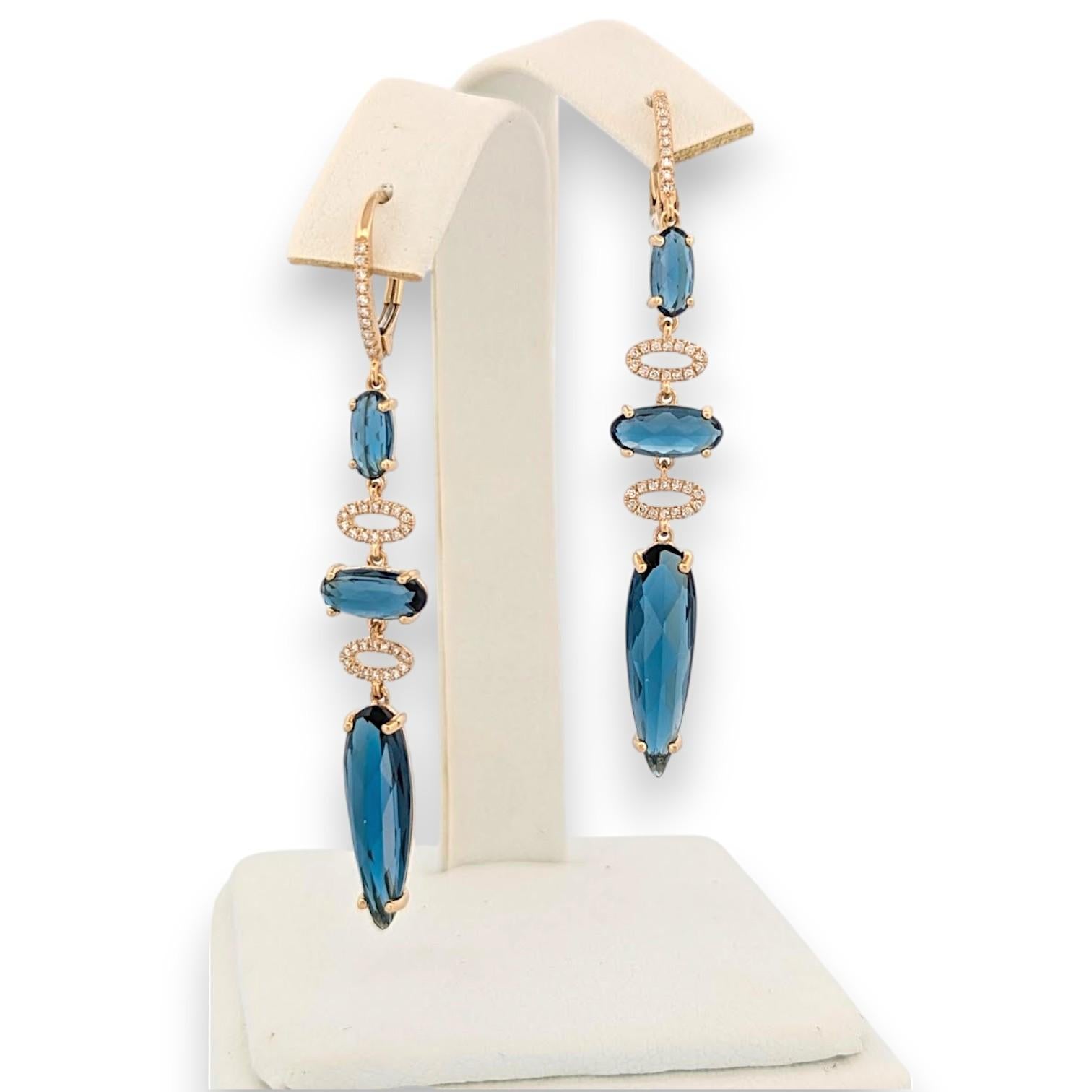 Stunning 14k yellow gold leverback earrings featuring 10.37ct natural London Blue Topaz & 0.16ct diamonds. Handcrafted statement jewelry perfect for special occasions.

Like capturing the midnight sky in golden constellations, our Astraea earrings