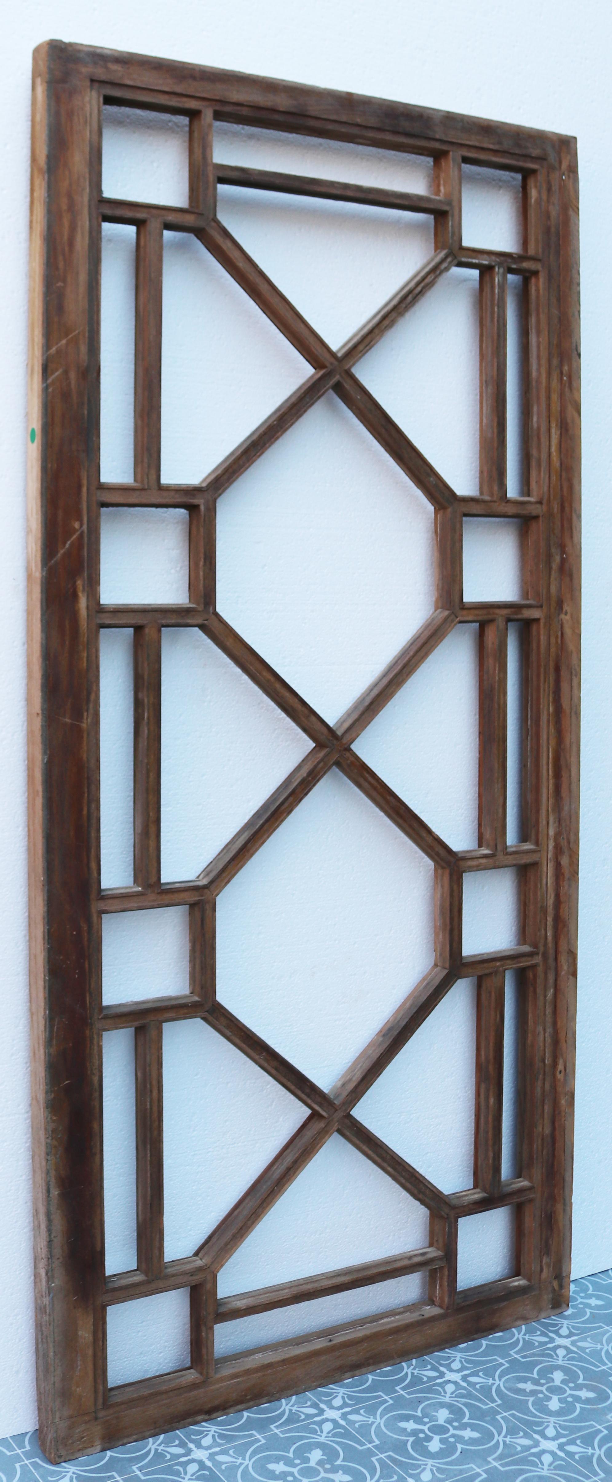 A reclaimed door or window with astral glazing, made from teak.