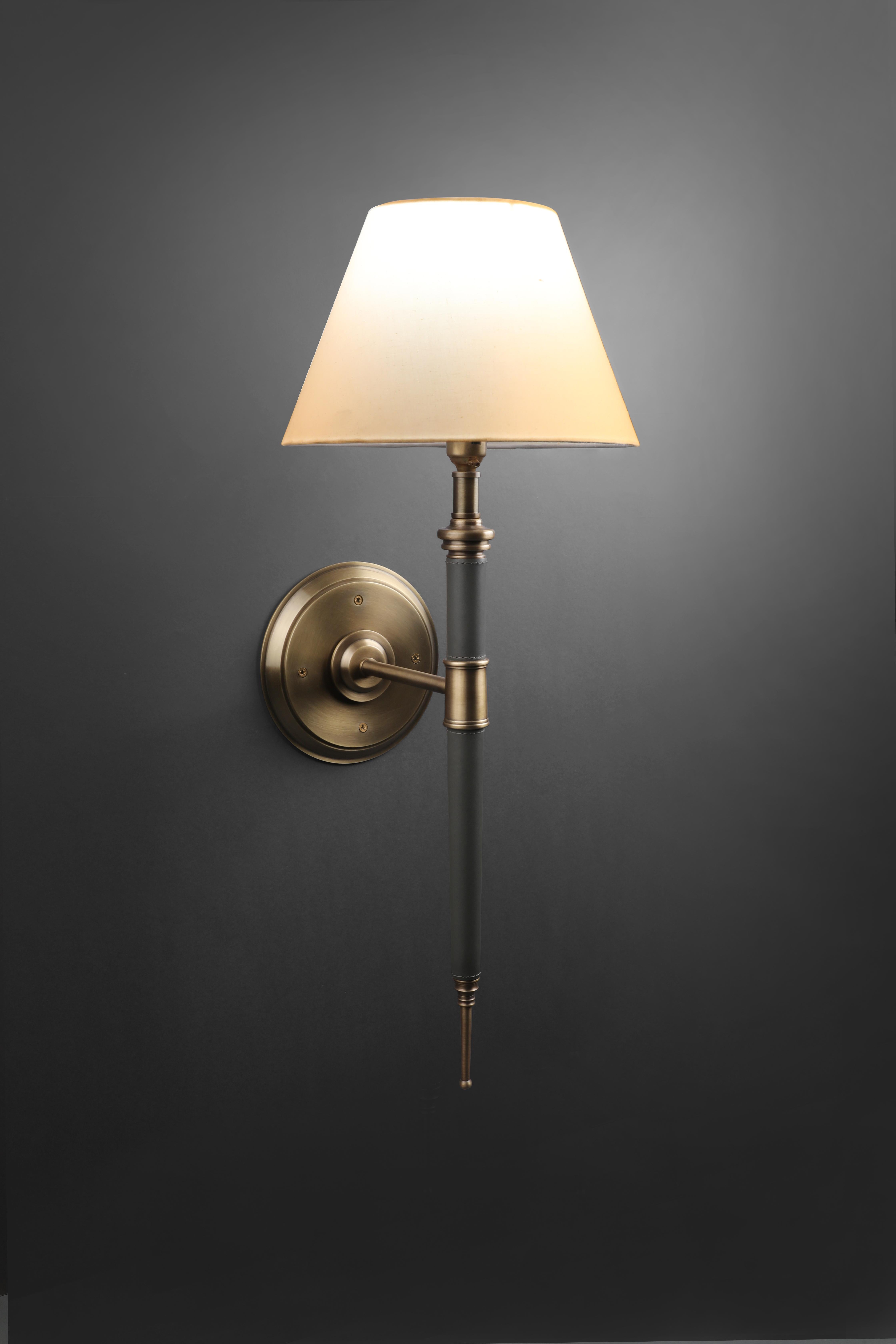 Astrelli wall sconce by Madheke
Dimensions: W 25 x D 30 x H 64 cm.
Materials: Brushed antique bronze body with leather encasing detail.

All our lamps can be wired according to each country. If sold to the USA it will be wired for the USA for
