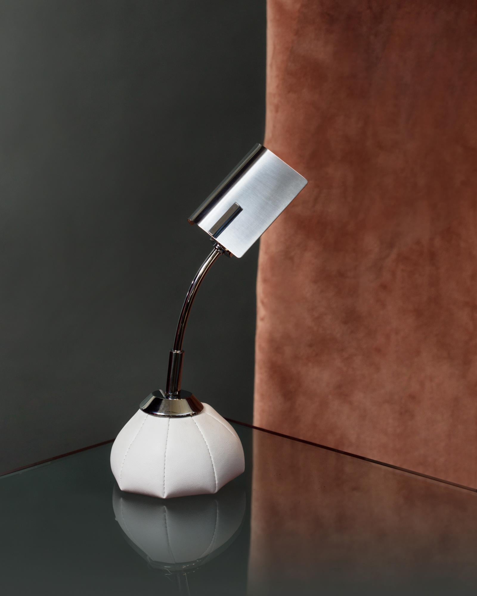 A lamp you can play and have fun with. This is how Brotto described this lamp. A small jewel made of leather and chromed brass that conceals the free spirit of the designer-artist.
