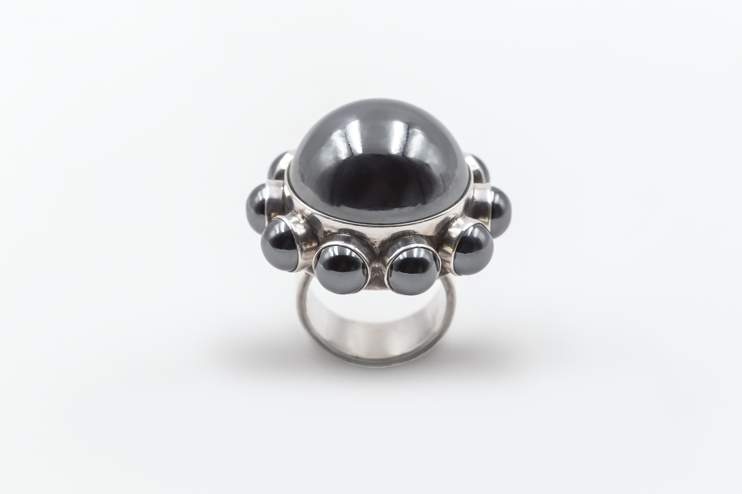 Ca 1970’s

Sterling silver - Hematite

Rare Model #166 designed by Astrid Fog for Georg Jensen

Diam 3,4 cm (1,34 inches)

Size 53

Marked : Georg Jensen in dotted oval - 166 - Denmark 925

In 1969, Astrid Fog released her first jewelry collection