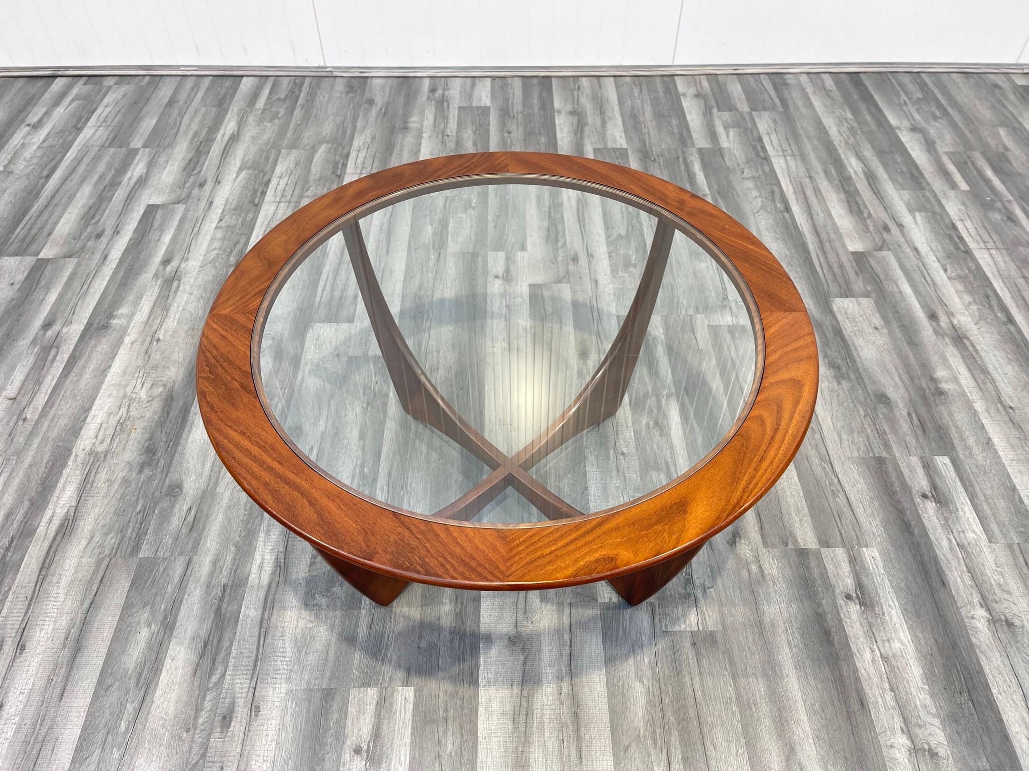 This Astro round stained teak and glass coffee table was designed by Victor Wilkins for G-Plan, and was produced in England around the 1960s.

As always with these vintage G Plan tables, there are some scratches to the glass. These are almost