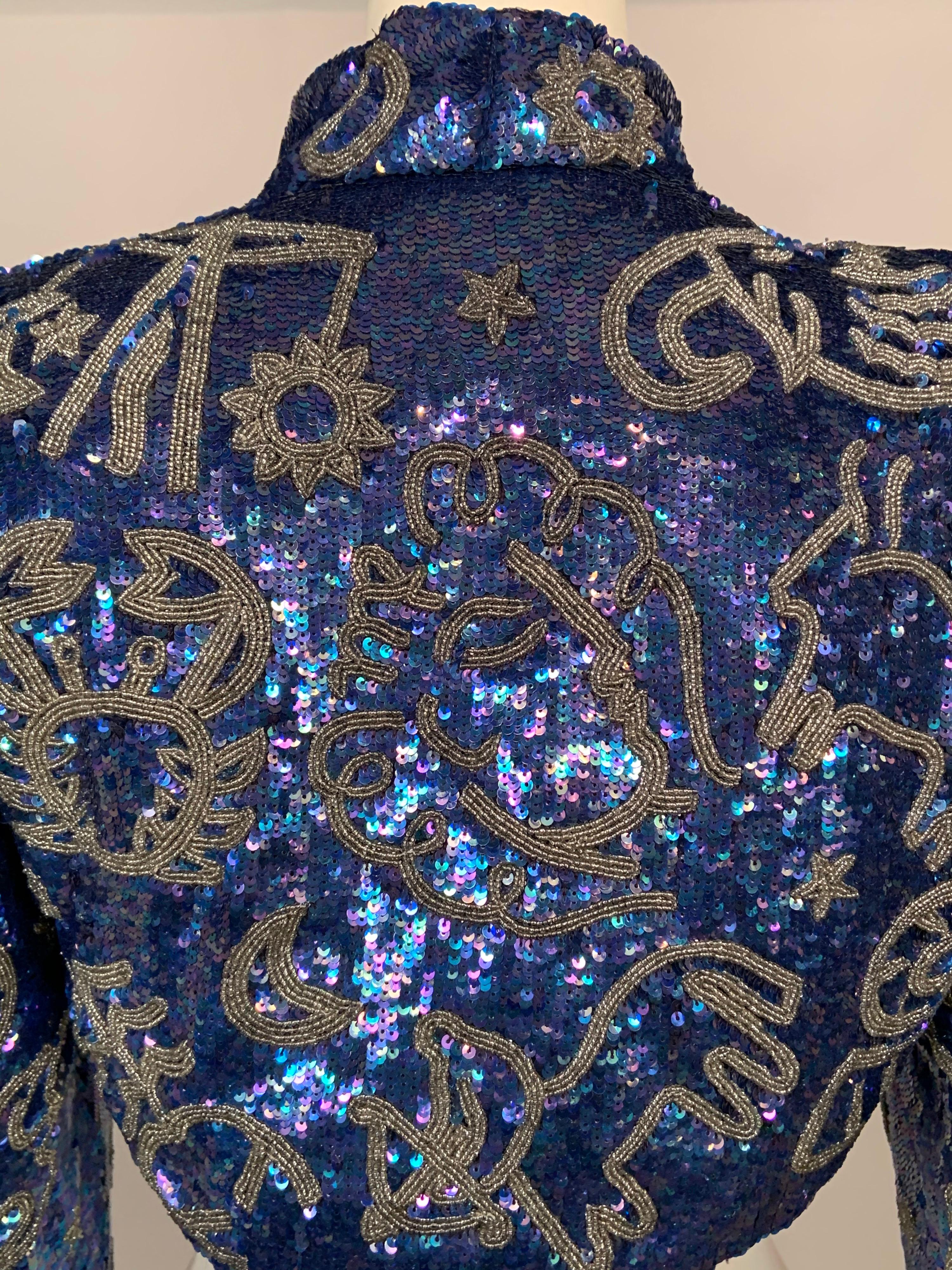Glistening blue opalescent sequins cover the surface of this striking bolero. The twelve Signs of the Zodiac are done in silver caviar beads, in addition to the beaded sun, moon and stars that are scattered across the jacket. Schiaparelli is well