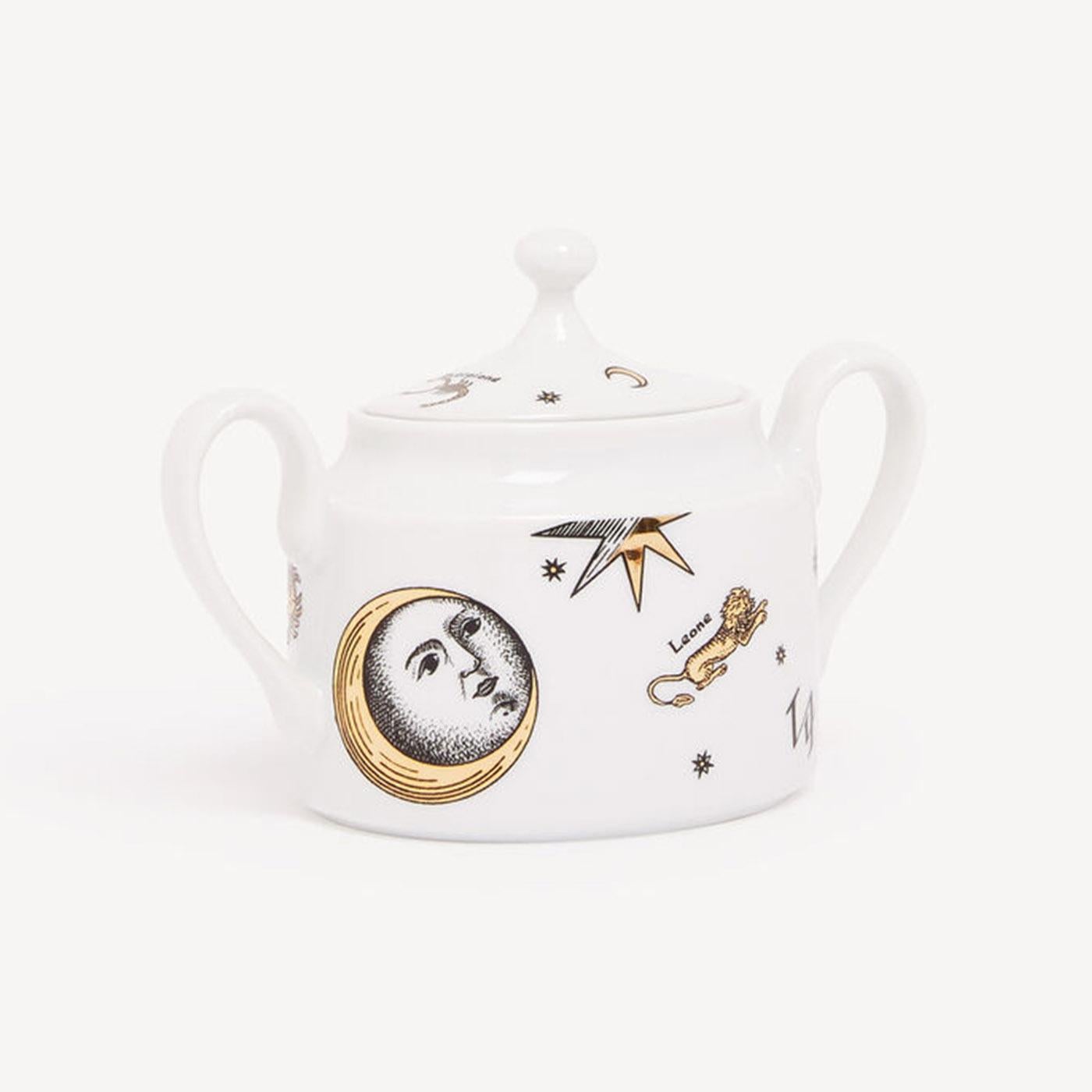 Precious zodiac decorations grace this hand-decorated porcelain sugar bowl with gold accents, transferring Fornasetti's imagery to an object for daily use and thereby transforming it into a collector's item. Any minor discrepancies between similar