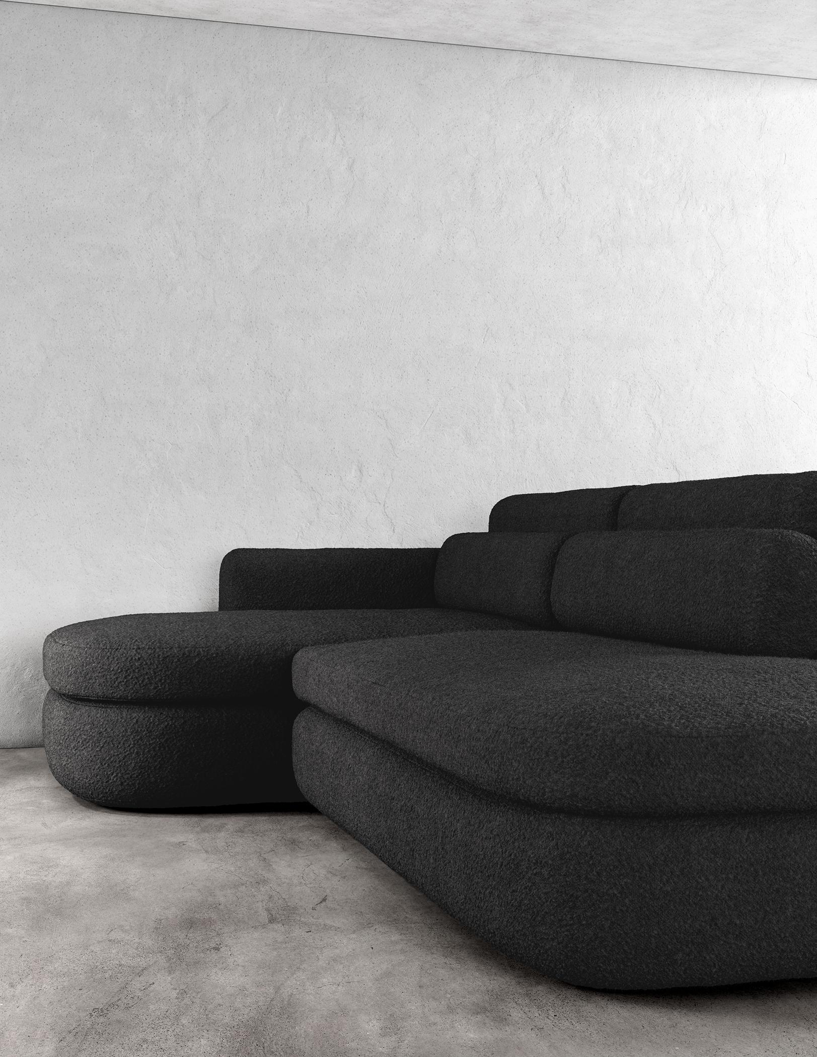 ASYM SECTIONAL – Modernes asymmetrisches Sofa aus schwarzem Bouclé

Das Asym Sektionssofa ist ein atemberaubendes Möbelstück, das sowohl raffiniert als auch schlicht ist und mit seinen asymmetrischen Designelementen eine einzigartige und moderne