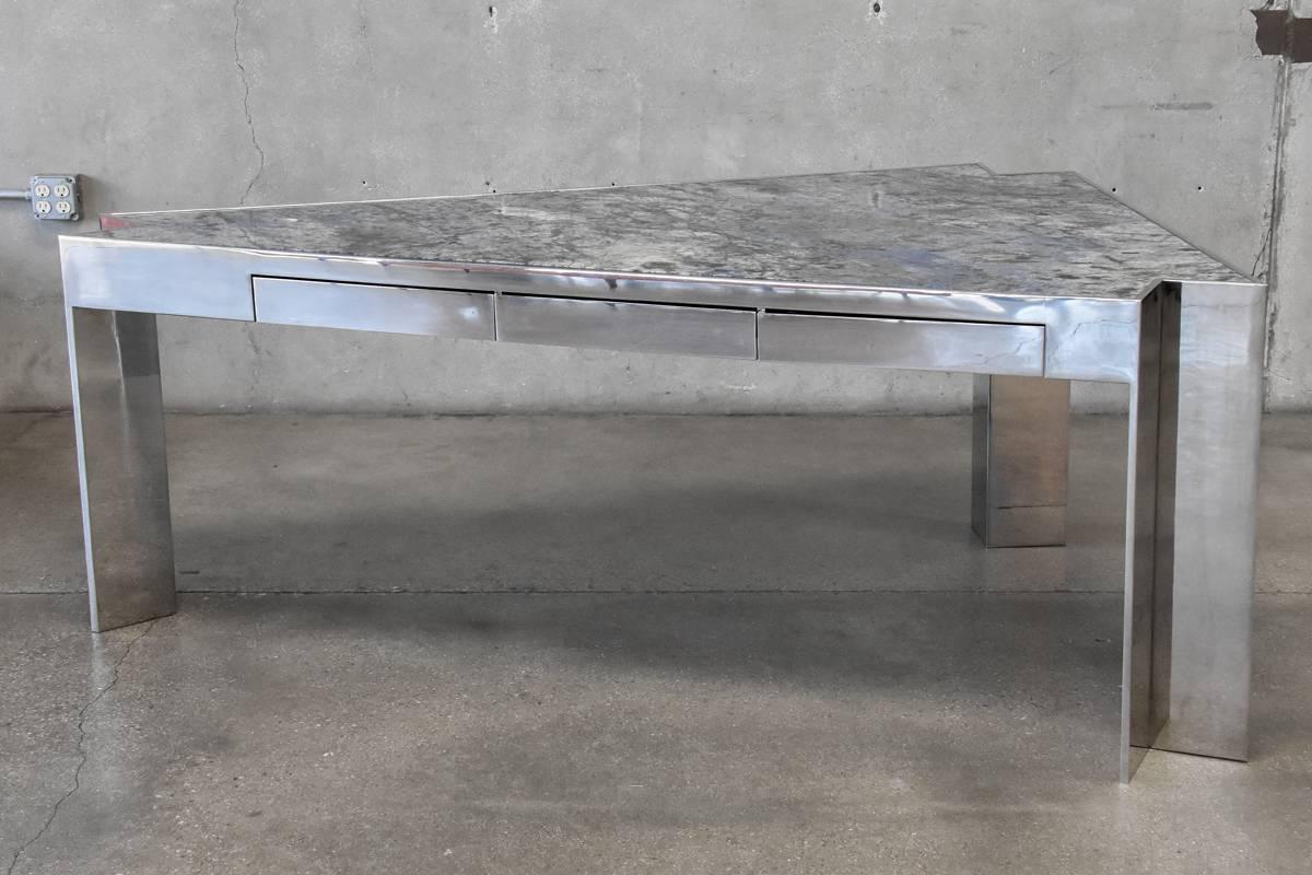 A monumental granite and polished steel executive desk attributed to Leon Rosen for the Pace Collection. This piece is identical in its design and construction to his 'mezzaluna' desk designed for Pace, with this being a triangular form instead of a