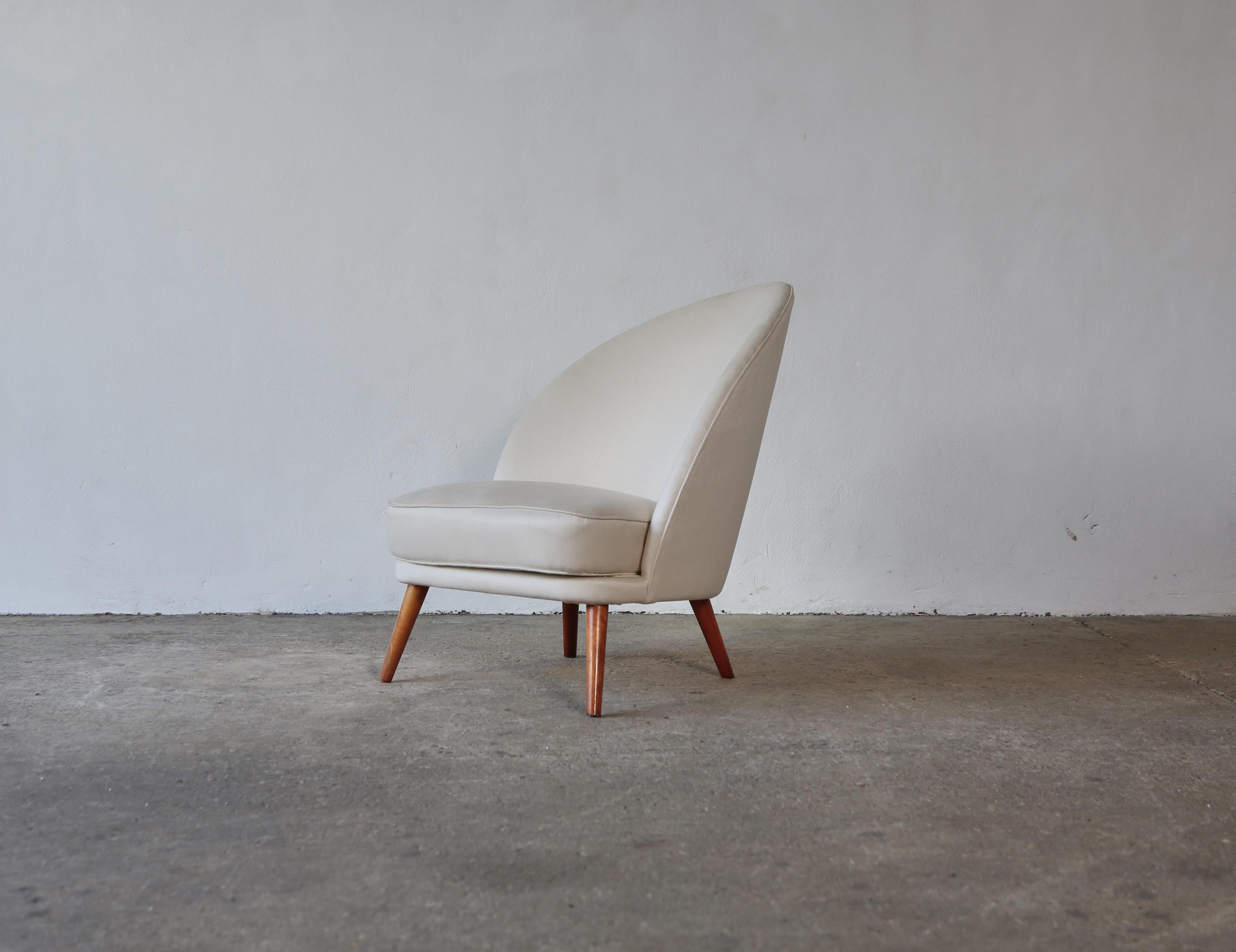 A Swedish Modern asymmetrical chair, attributed to Arne Norell, 1950s. Reupholstered in Rose Uniacke French Chalk linen. Fast shipping worldwide.


