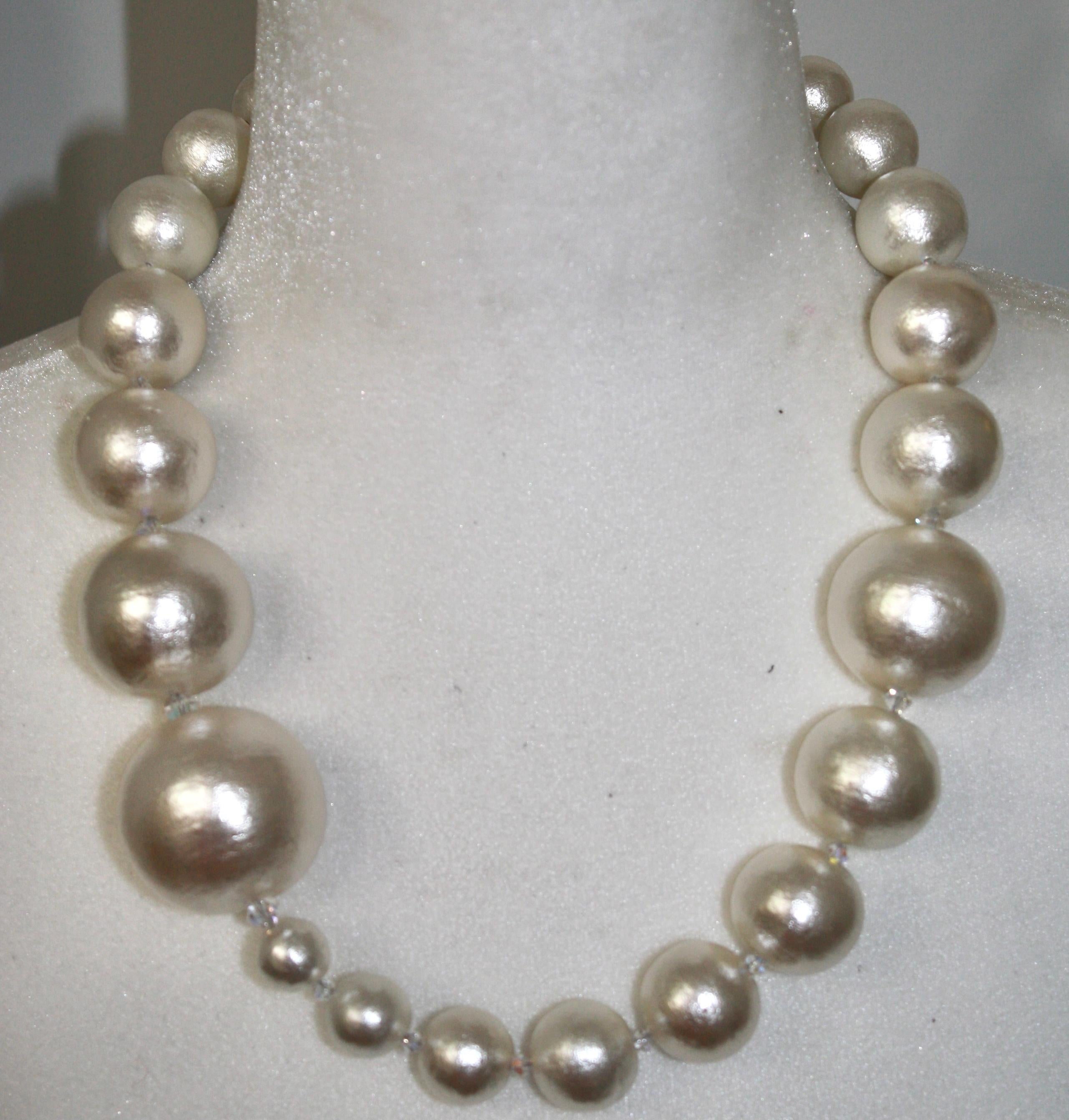 Super light cotton pearl with Swarovski crystal adorned magnetic clasp. Designed by Yasco Otomo her jewelry has a bulky look but is wondrously light! Hand made in Paris 
Largest pearls are 120mm