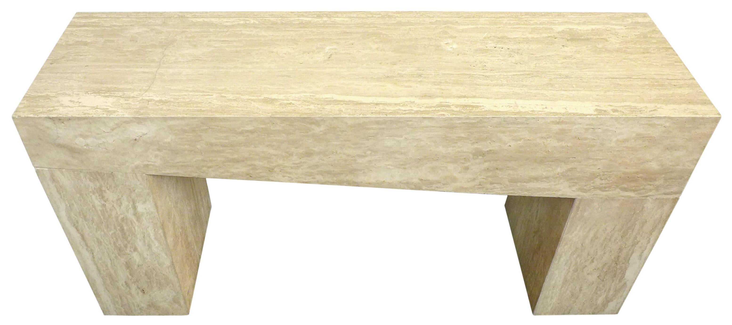 A wonderful, asymmetric travertine console. A massive form constructed of mitered travertine slabs. A tapering-underside top sits atop two pedestal legs giving the impression of one gigantic block of stone; a fantastic silhouette. Classic travertine
