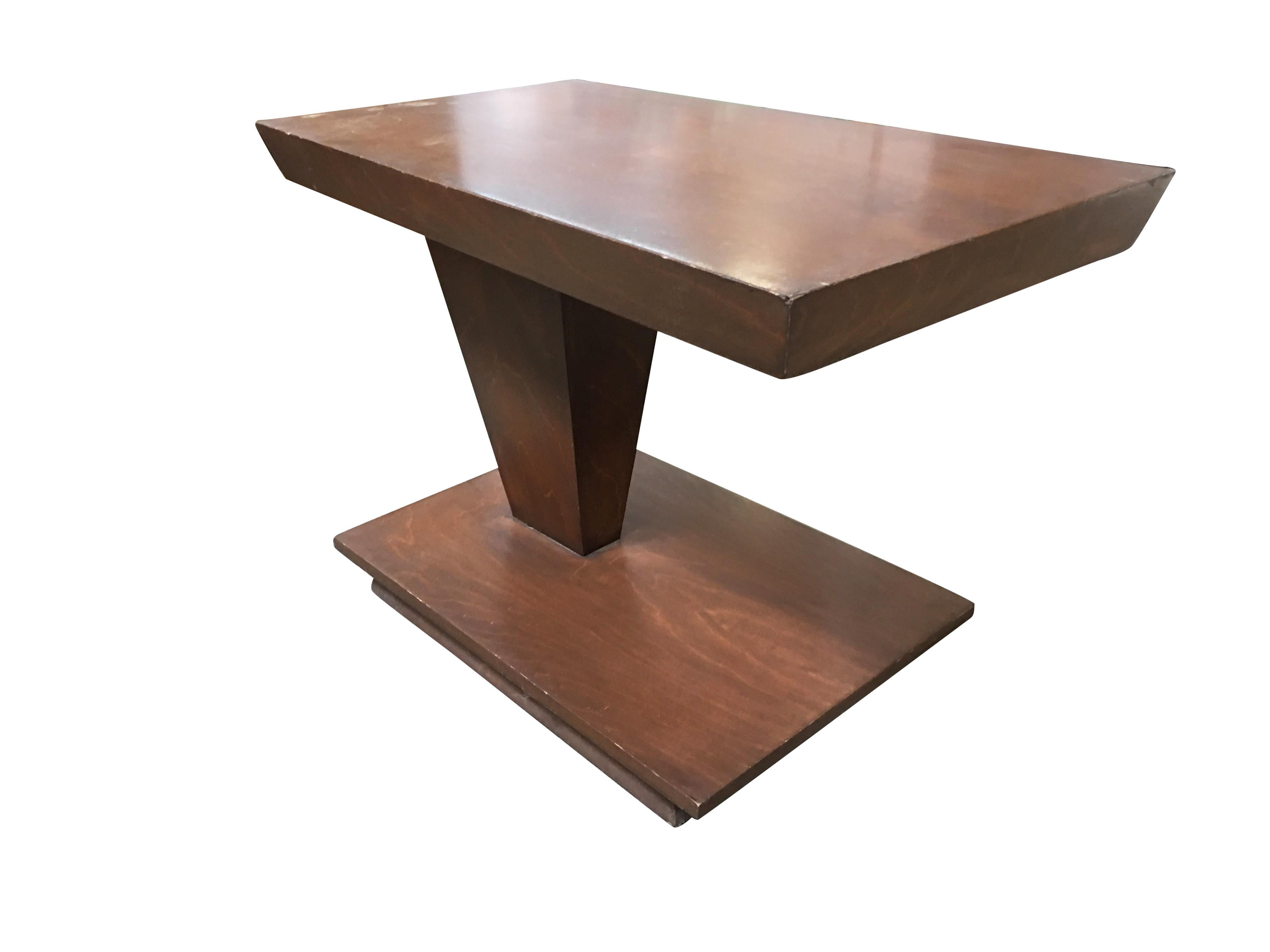 Unique asymmetric midcentury walnut side table pair featuring shorten base holding up a larger top by one a single V-shaped base on one side.