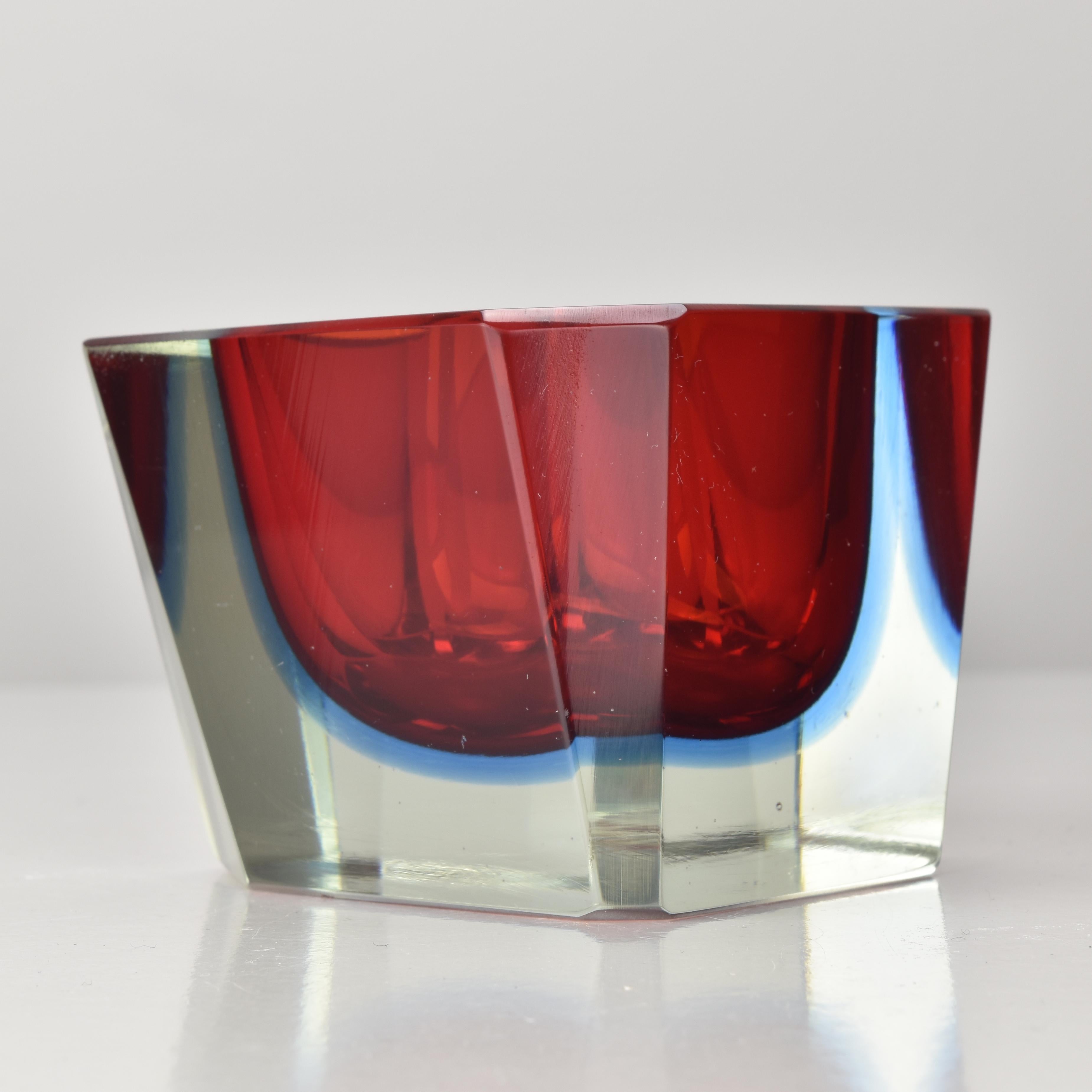A striking asymmetric Murano Sommerso block dish attributed to Flavio Poli, crafted in the 1960s using the renowned Sommerso (submerged glass) technique. This sculptural piece features a vivid red core encased in a layer of cobalt blue, all captured