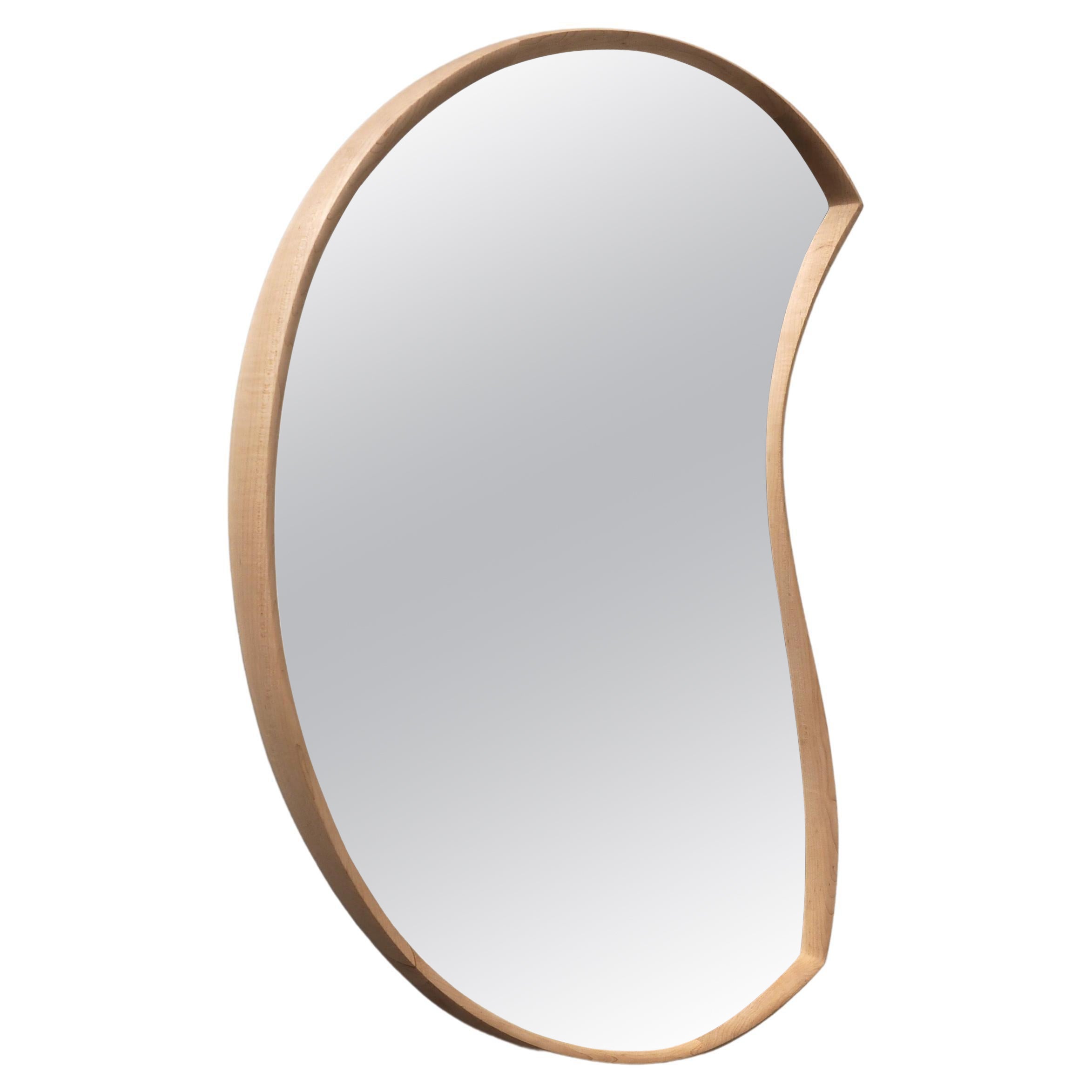 'Moon Mirror' by Soo Joo is a wooden wall mirror with a timeless and asymmetric form. Moon Mirror is hung with a custom-made steel french cleat and hangs flush on the wall. This is the slightly larger version, at 95 x 55 cm in size.  

This mirror