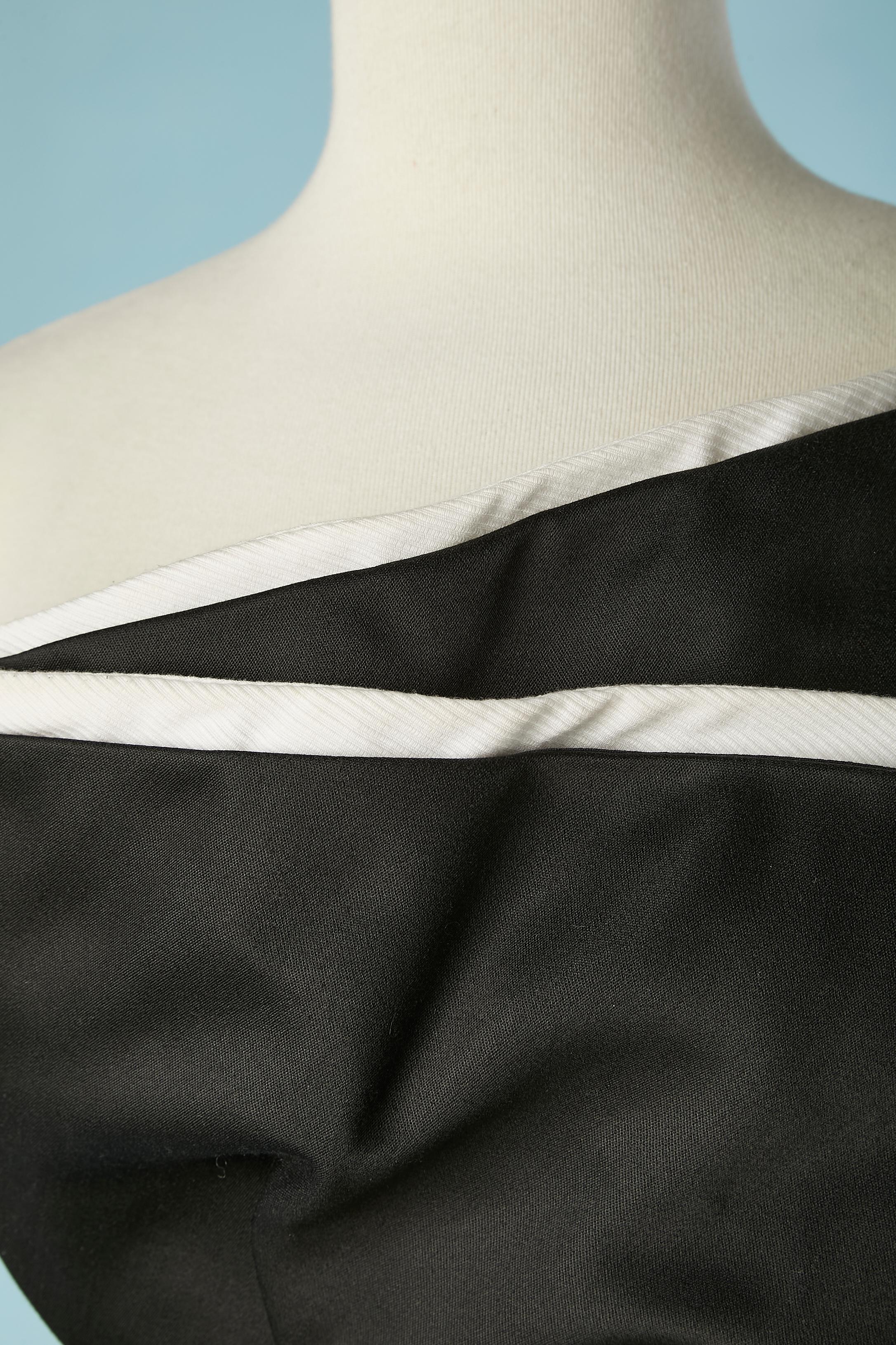 Schwarz-weißes, asymmetrisches Bustier-Abendkleid. Kein Stoffetikett, aber beide Stoffe scheinen aus Baumwolle zu sein (der weiße hat ein gestreiftes Ton-in-Ton-Muster). Das schwarze Futter ist wahrscheinlich aus Acetat. 
Das Bustier mit Knochen und