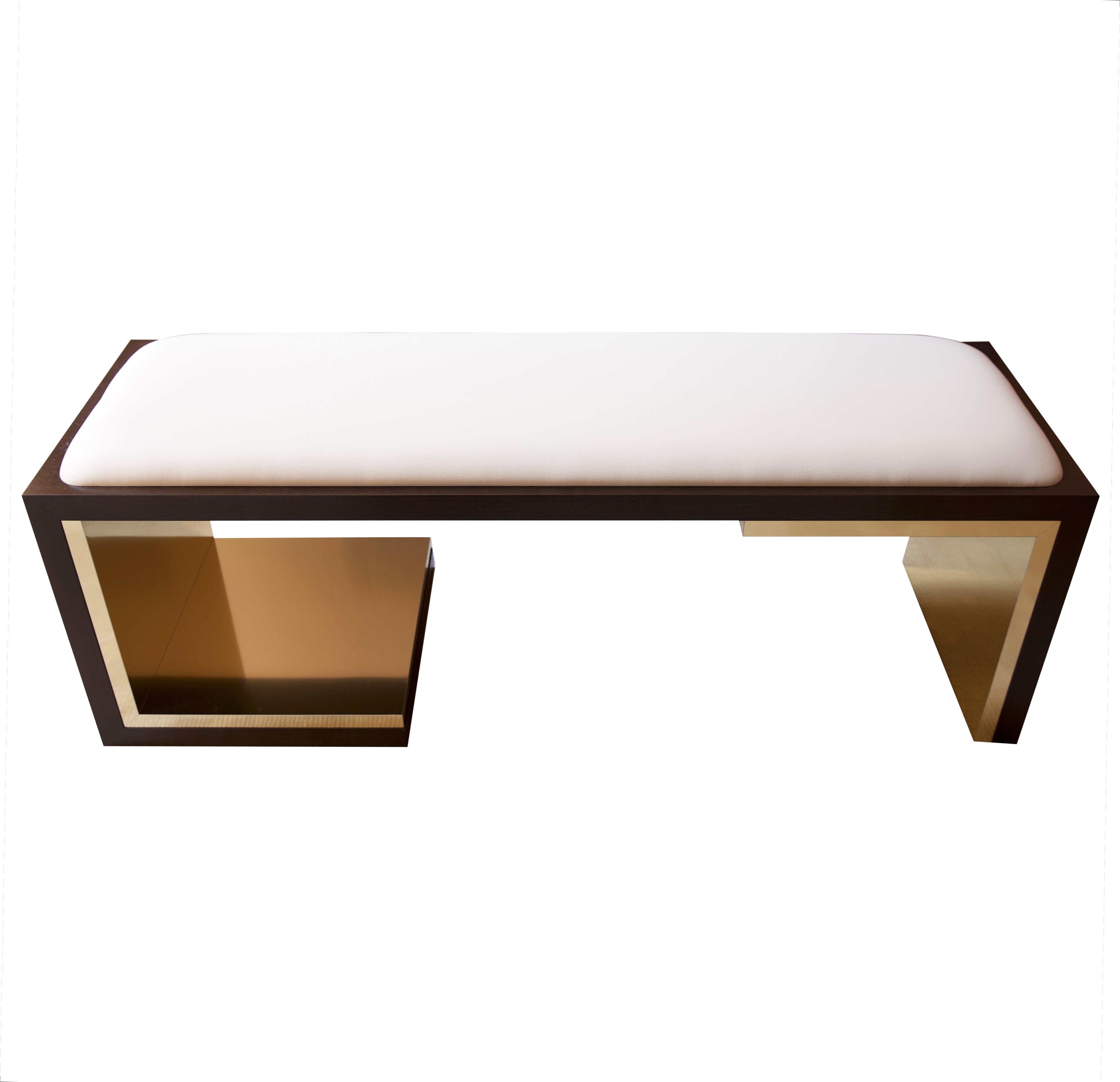 LT signature bench 

The clean lines of this asymmetrical bench are formed from a rich mix of solid walnut, polished brass, and vegan leather. Brass inlay is a subtle play on the collection's LT signature. 
 
Overall: 50”W x 16”D x