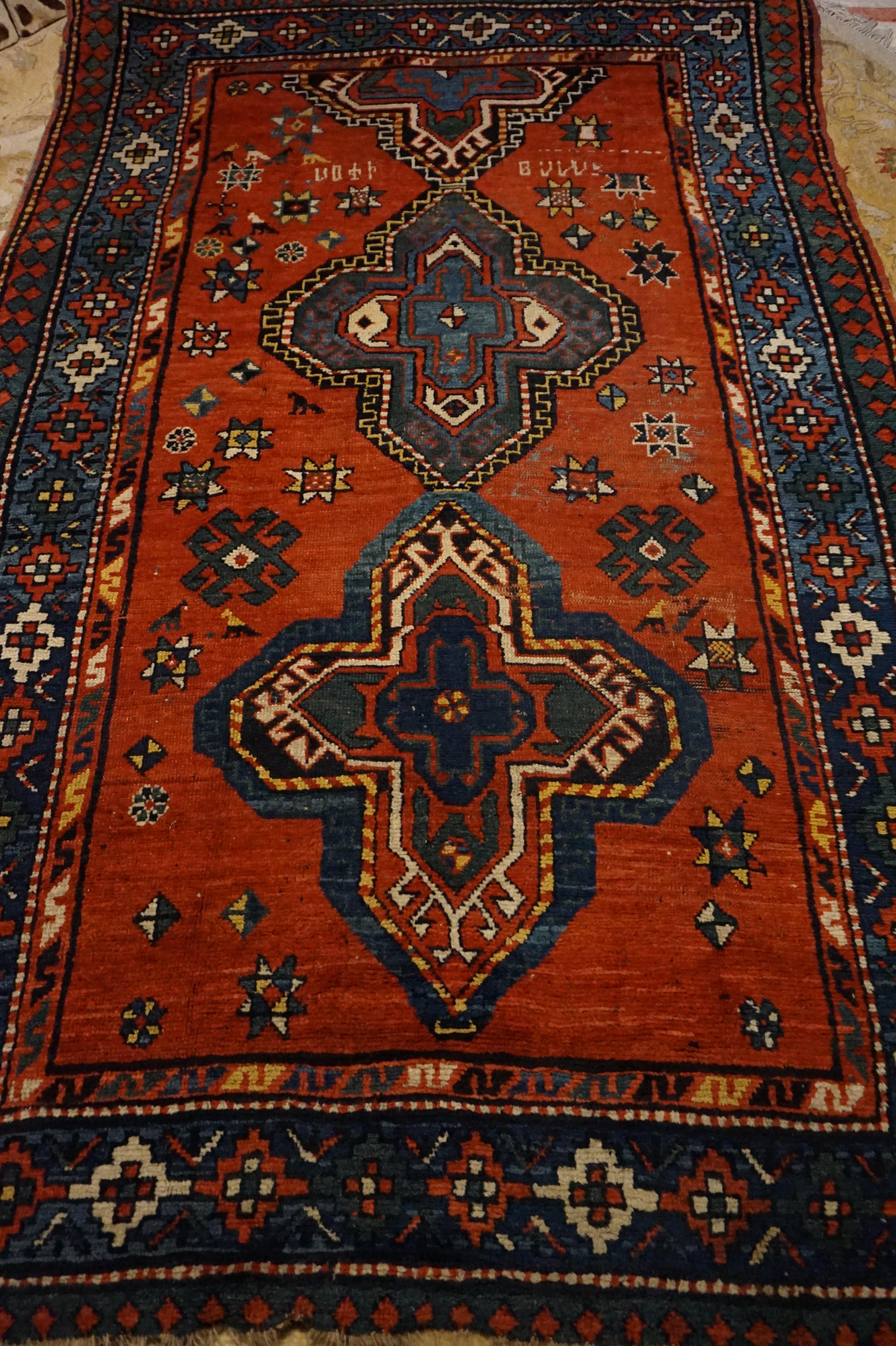 Charming rustic Caucasus region tribal village rug with vibrant natural hues and asymmetrical kite medallion pattern. Large open fields with signatures, star motifs and vibrant variegated colours make this rug exude warmth and character. The abrupt