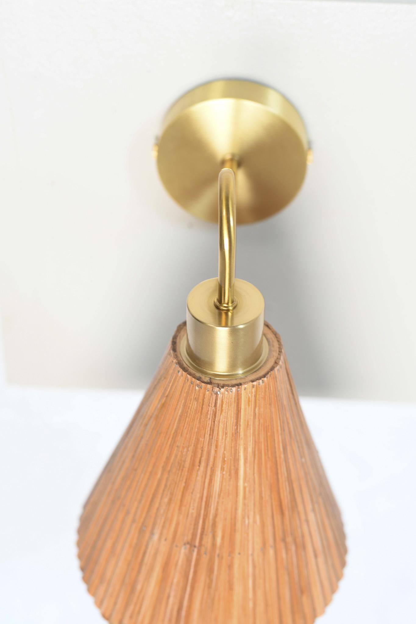 Asymmetrical Cone Wall Sconce, Handcrafted Light, Inspired by Nature

This wall sconce is handcrafted from natural rattan, celebrates the imperfect beauty found in organic materials- no two pieces are ever quite the same.

The brass-plated fixture