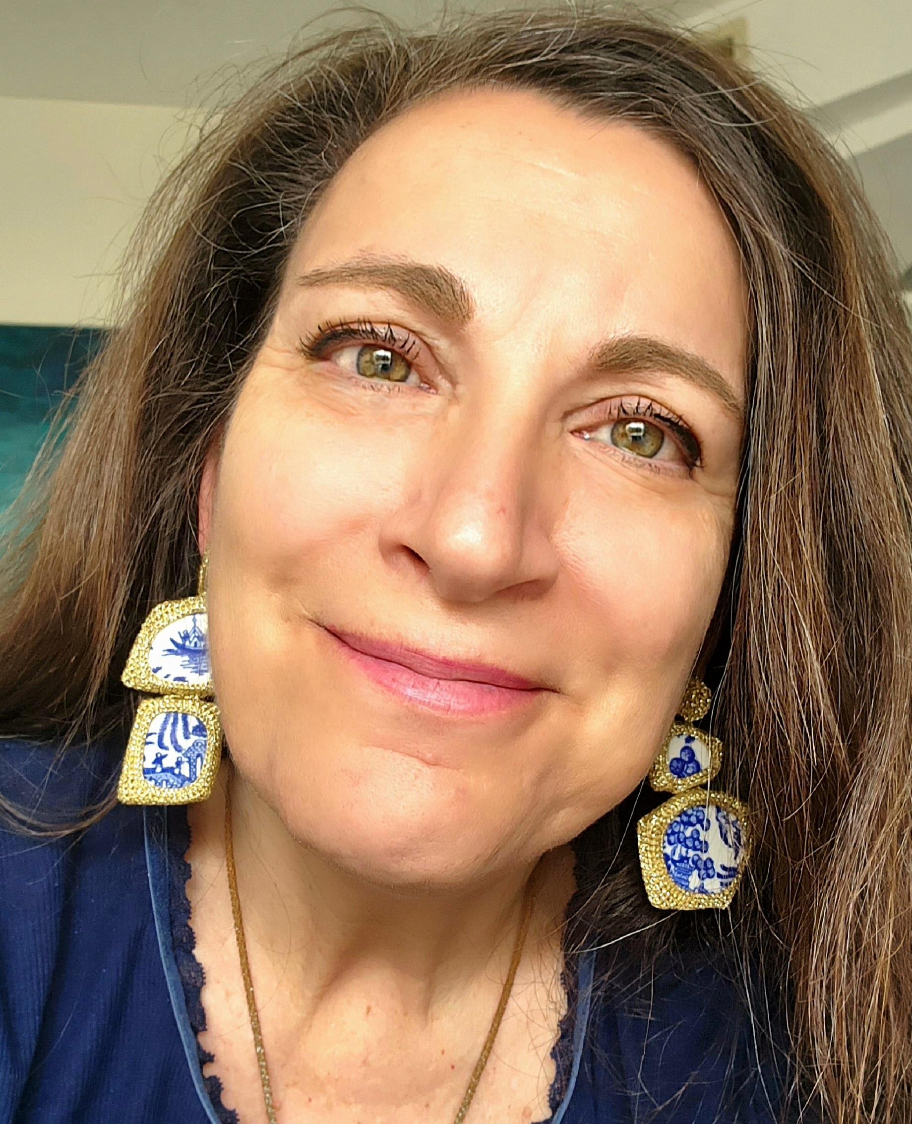These are beautiful, one of a kind, asymmetrical pair of crochet earrings. These are crochet with golden smooth passing thread. The thread has no metal content and will not tarnish. The ceramic pieces are blue and white and are taken from a cut